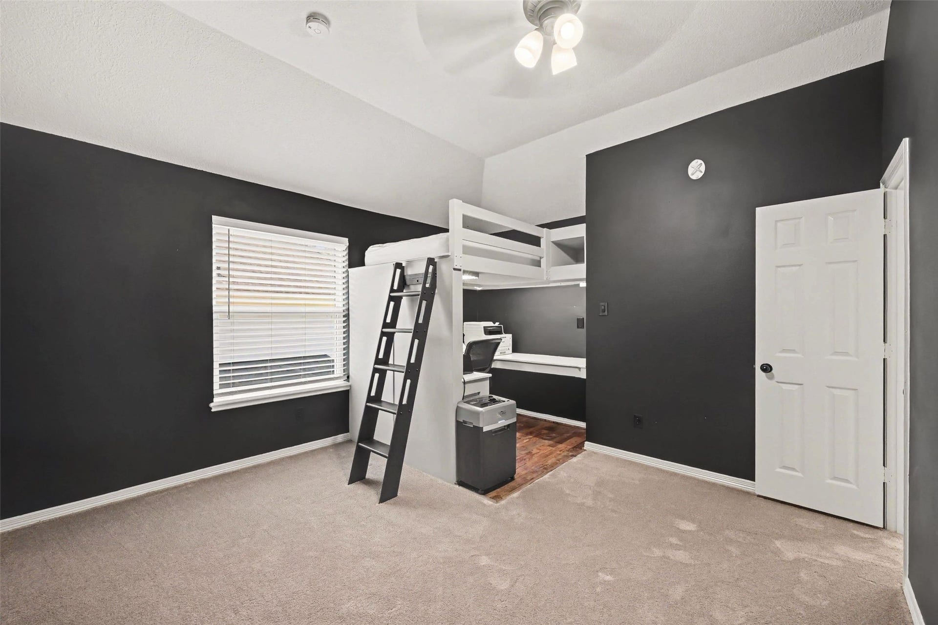 2907 Winding Shore Lane, Katy, TX 77450 Chic bedroom with modern dark walls features a loft bed and built-in desk, maximizing space and functionality. Large walk in closet.