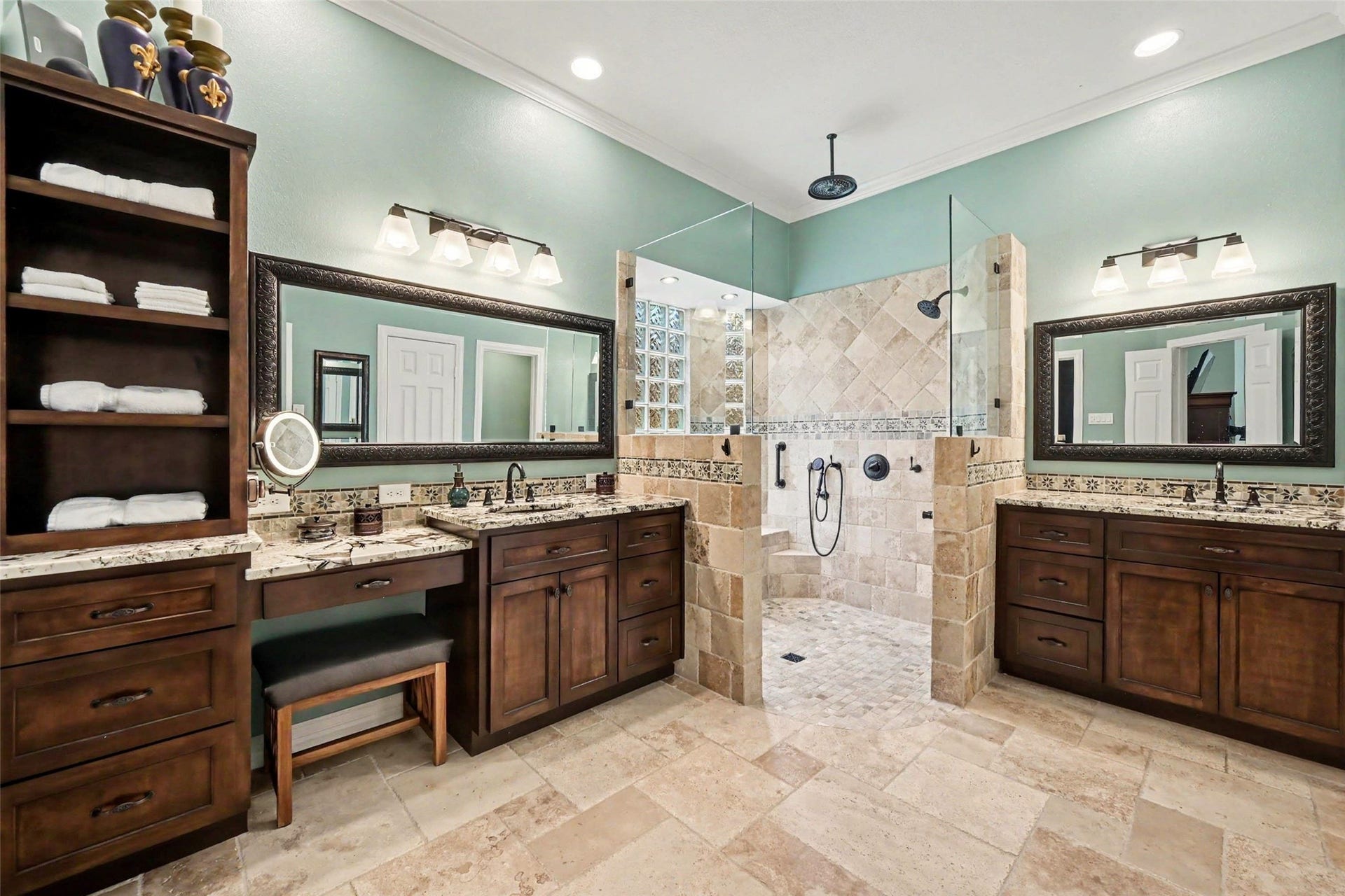 2907 Winding Shore Lane, Katy, TX 77450 UPDATED! Luxurious primary bathroom featuring dual vanities with granite countertops, a spacious walk-in shower with elegant tilework, and ample storage with rich wood cabinetry.