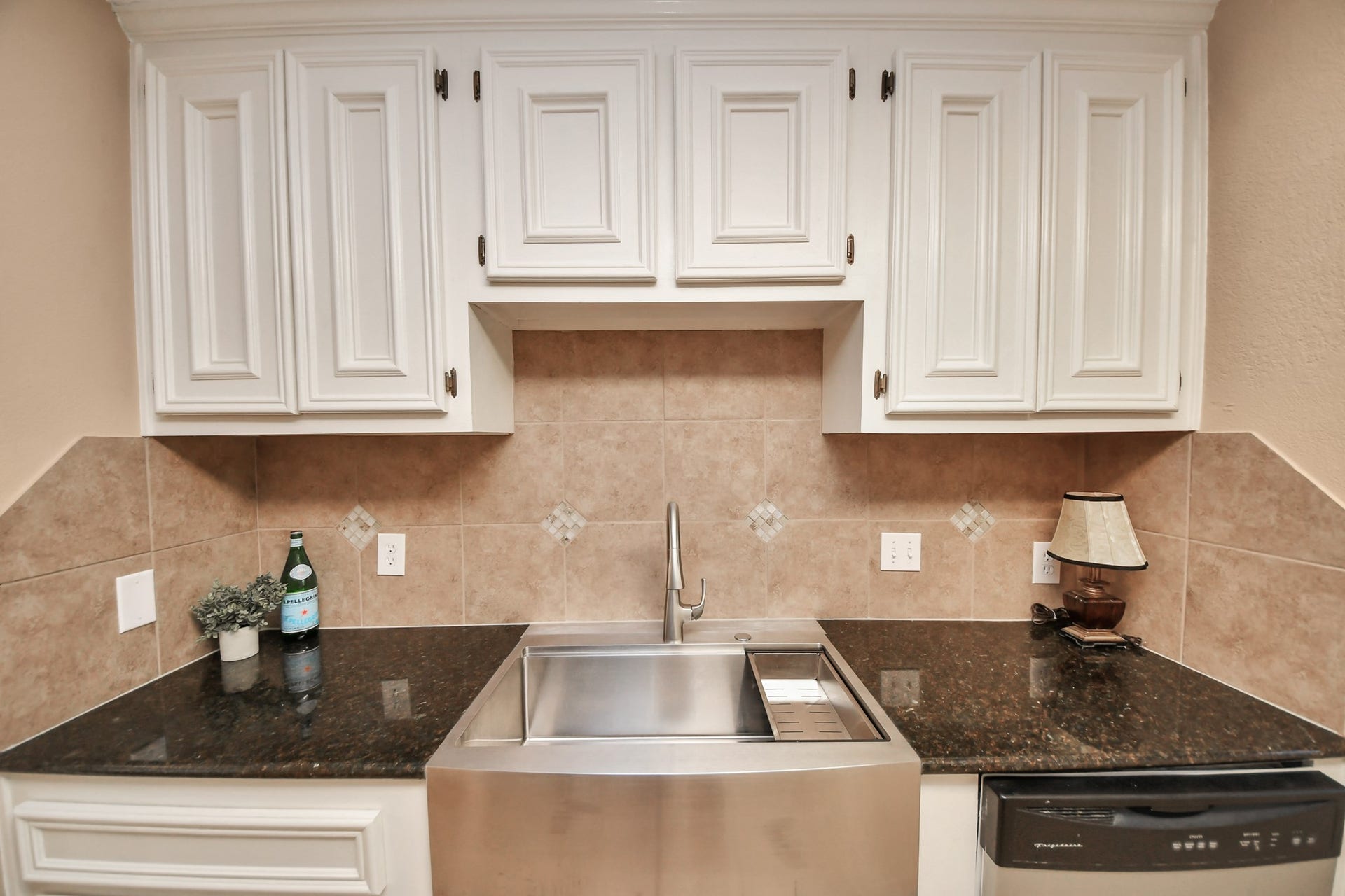 935 Grand Junction Drive, Katy, TX 77450 One of the kitchens standout features is its eye-catching stainless steel apron-front sink, combining farmhouse-inspired style with everyday practicality.
