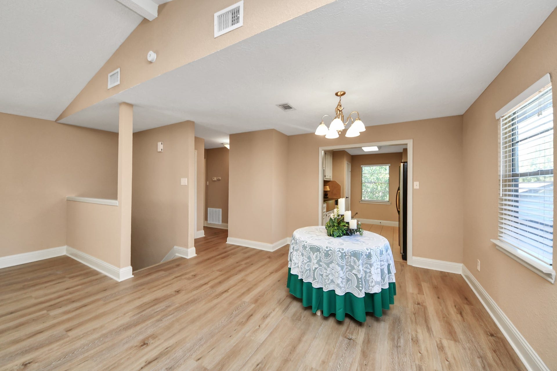935 Grand Junction Drive, Katy, TX 77450 Whether enjoying a quiet morning coffee or hosting a festive dinner, this versatile dining area provides the perfect setting. Featuring attractive wood-look flooring, a traditional chandelier, and a window welcoming natural light, the space flows conveniently into the kitchen, making serving meals and entertaining guests effortless.