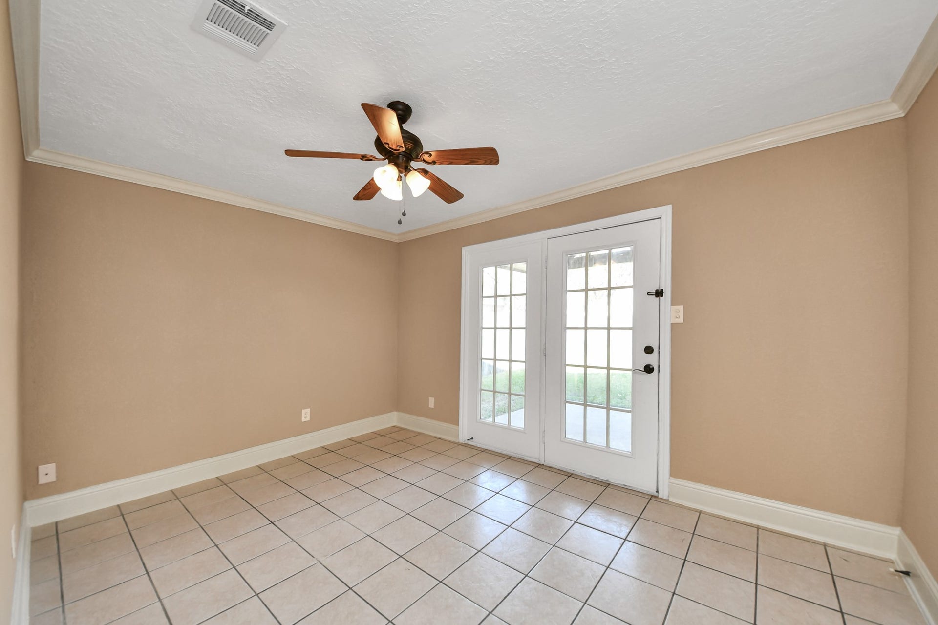 935 Grand Junction Drive, Katy, TX 77450 Imagine having a room where you can work, entertain, or simply unwind after a long day! This versatile first-level secondary bedroom features beautiful French doors that open directly to the backyard and covered patio, creating a seamless connection between indoor comfort and outdoor relaxation.