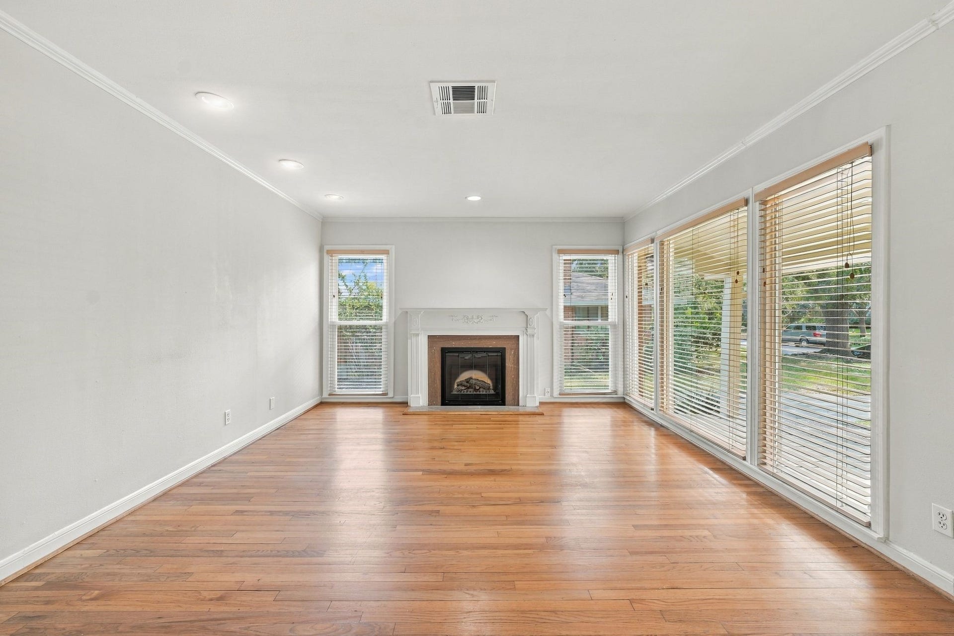 2206 Macarthur Street, Houston, TX 77030 Beautiful original floors, a fireplace and large windows along front wall make for an alluring living room