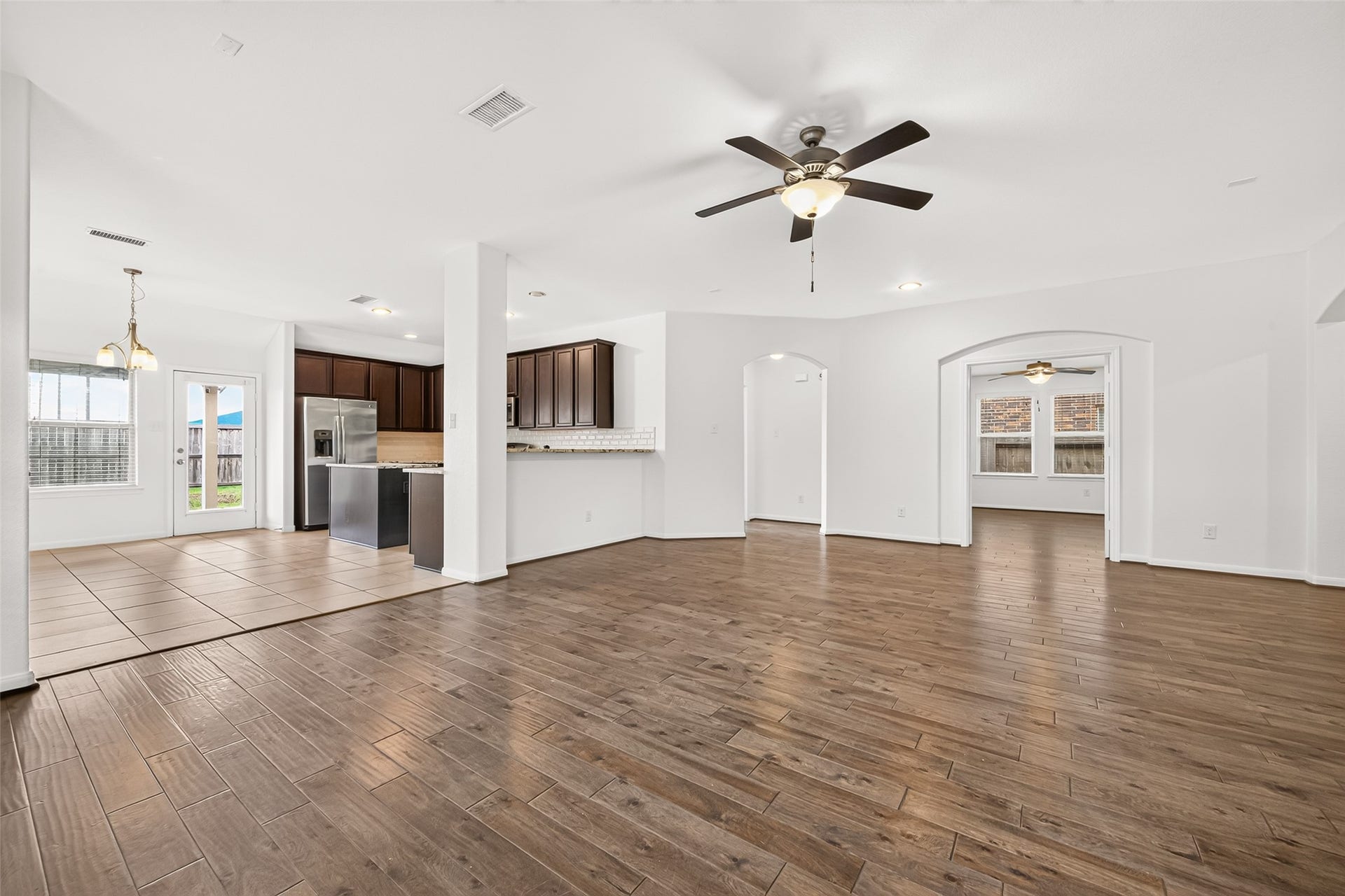 Open concept living/dining/kitchen floor plan with cozy fireplace.