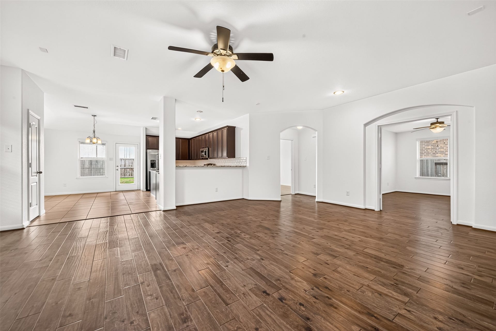 Open concept living/dining/kitchen floor plan with cozy fireplace.