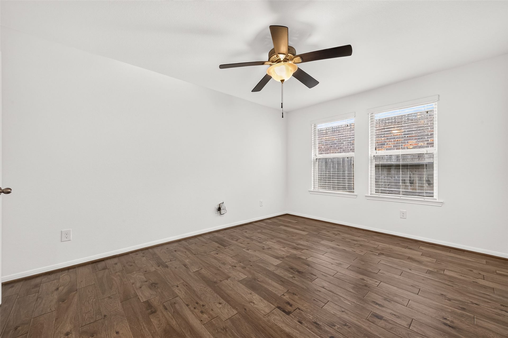 Spacious BONUS ROOM located off the living area can be used as a home office, gameroom, playroom, or fitness room. Features include wood look flooring, ceiling fan, and french doors for privacy.