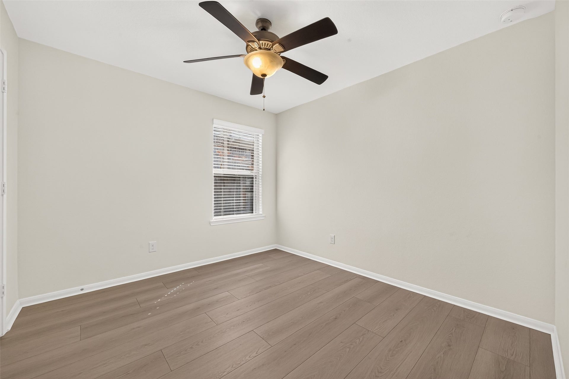 Secondary bedroom 2 with new flooring, fresh paint and ceiling fan