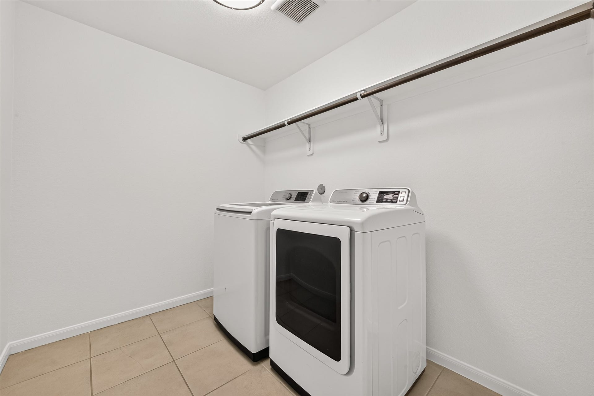 Utility room is tucked away right next to the garage entry. Washer and dryer are included in this rental.
