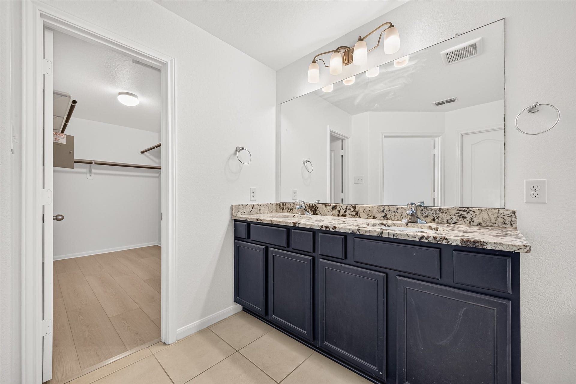 Primary bathroom with double sinks, soaking tub, and separate shower