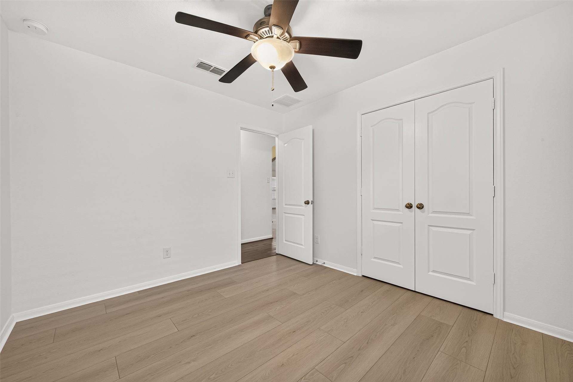 Secondary bedroom 2 with new flooring, fresh paint and ceiling fan
