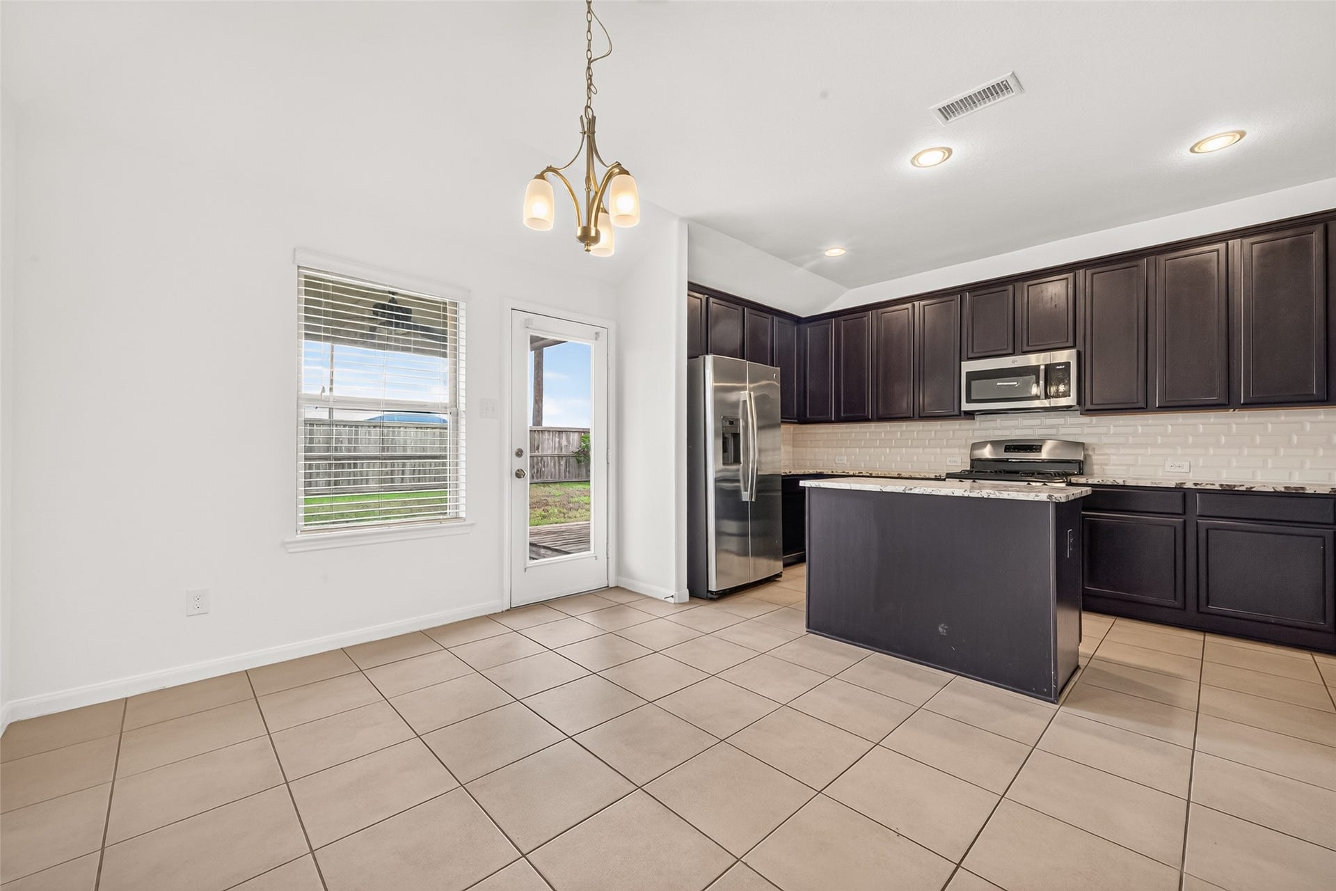 Dining/Kitchen area with direct access to the covered patio.