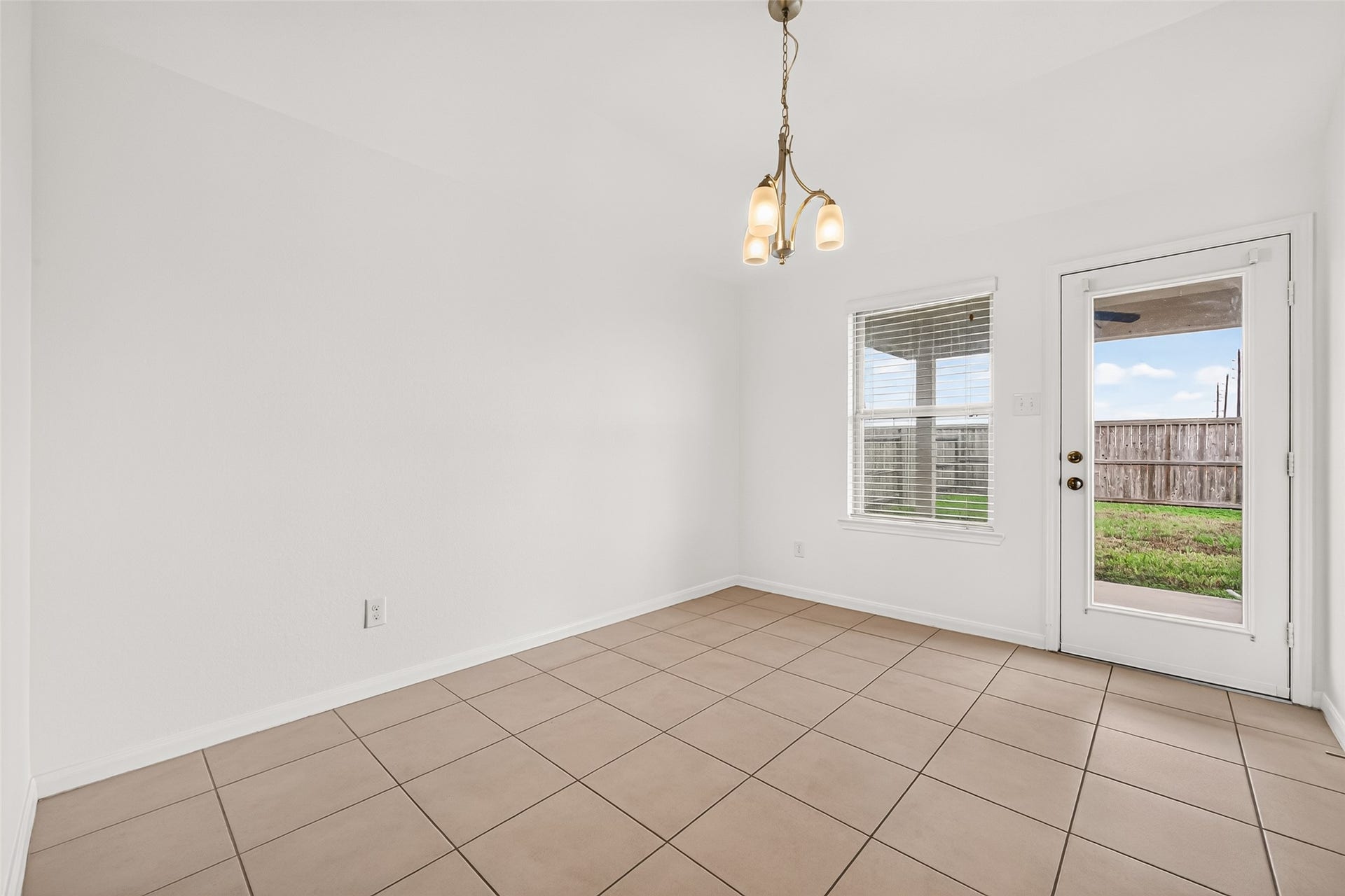 Dining area overlooking the covered patio and backyard.