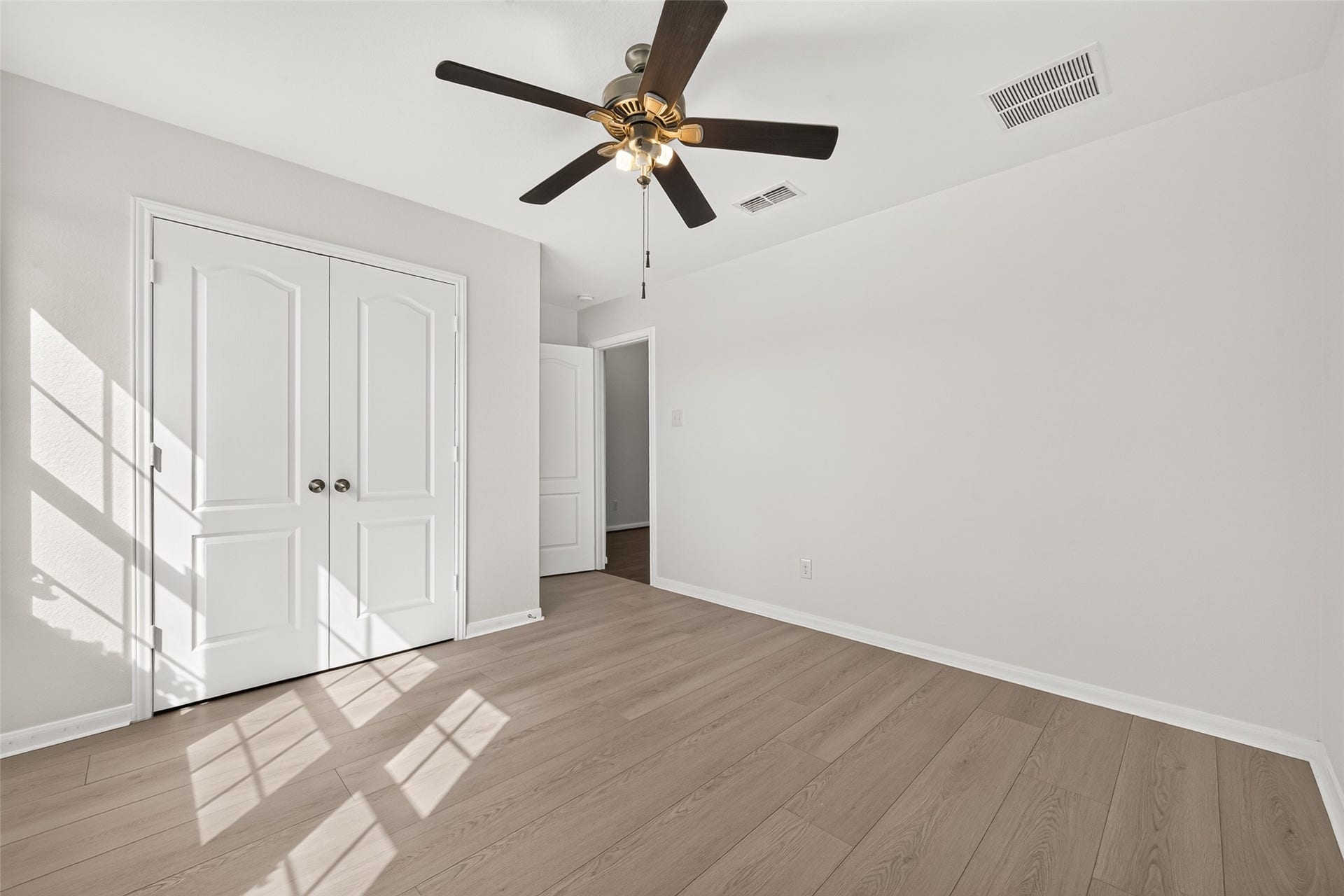 Secondary bedroom 1 at the front of the home with ceiling fan