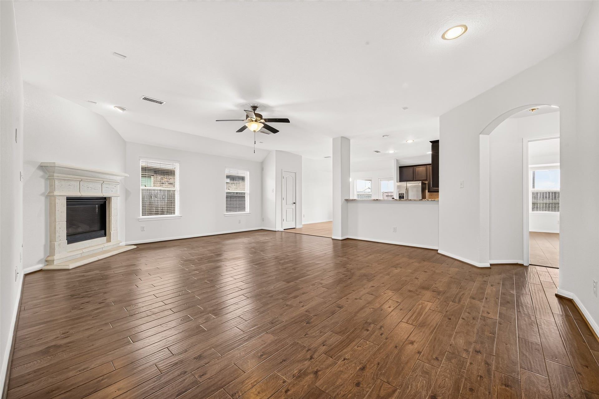 Open concept living/dining/kitchen floor plan with cozy fireplace.