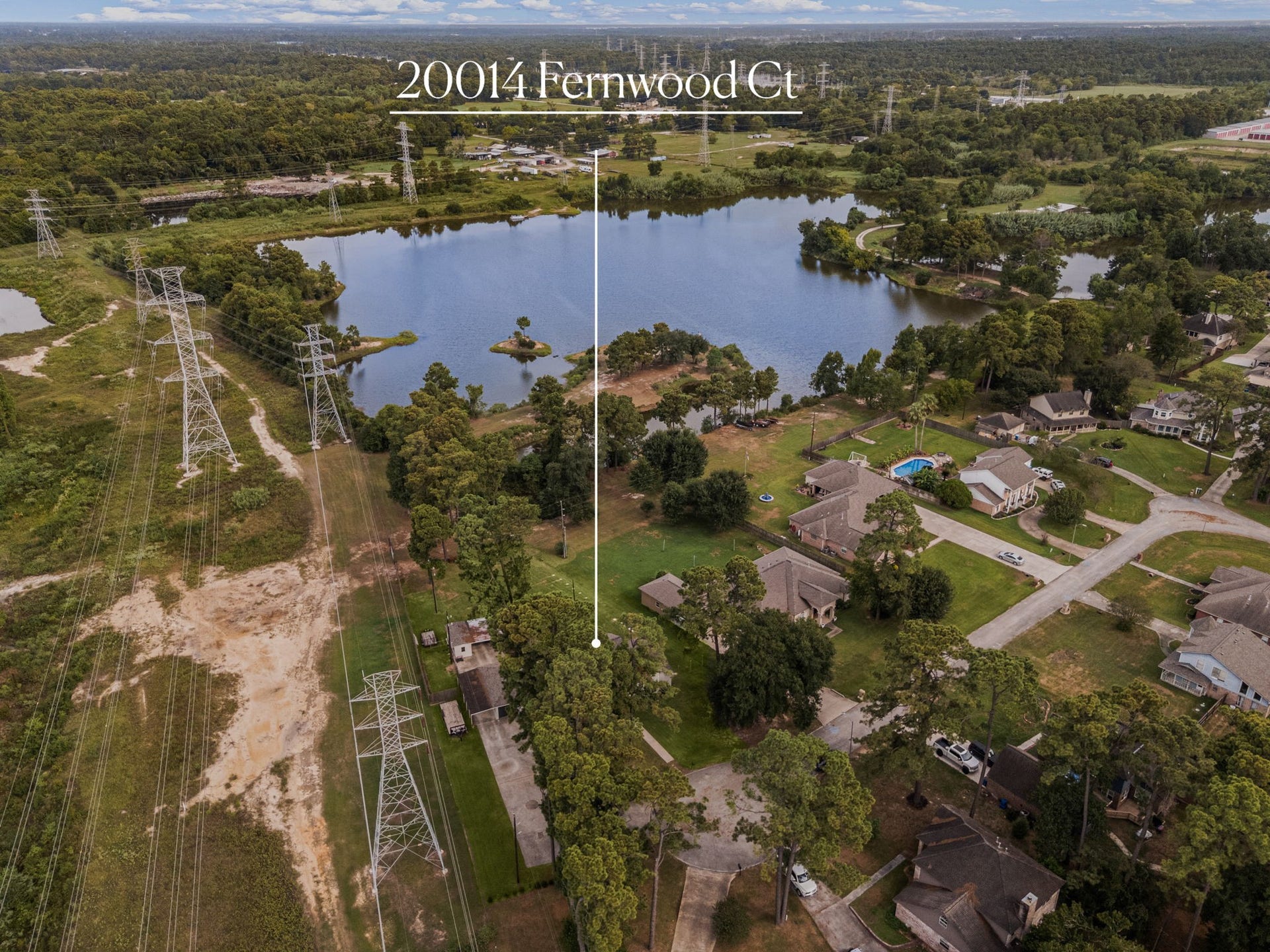 Elevated perspective captures the homes setting near the lake and surrounding natural landscape.