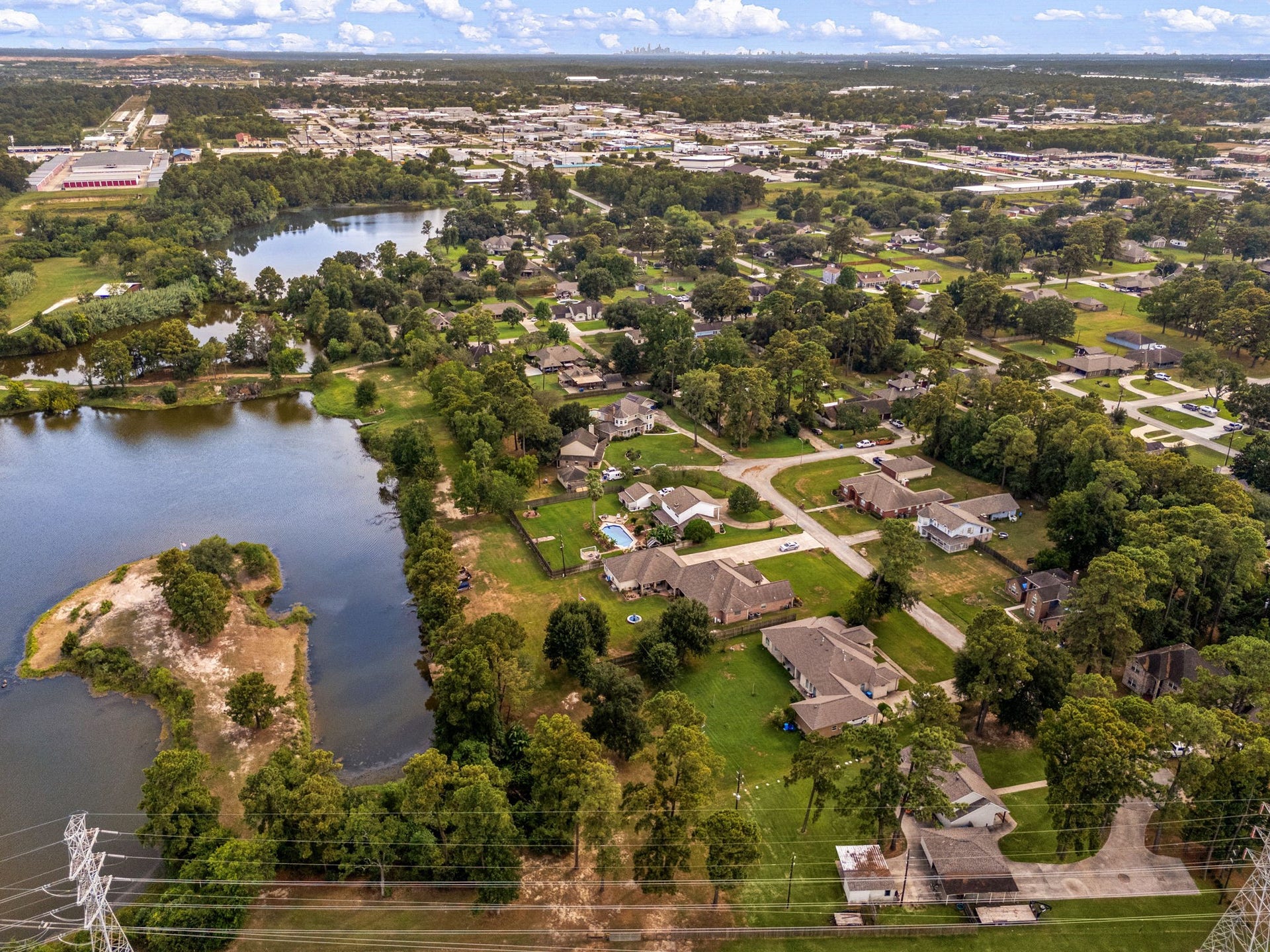 Wide aerial showcases the property and its proximity to nearby lake scenery.