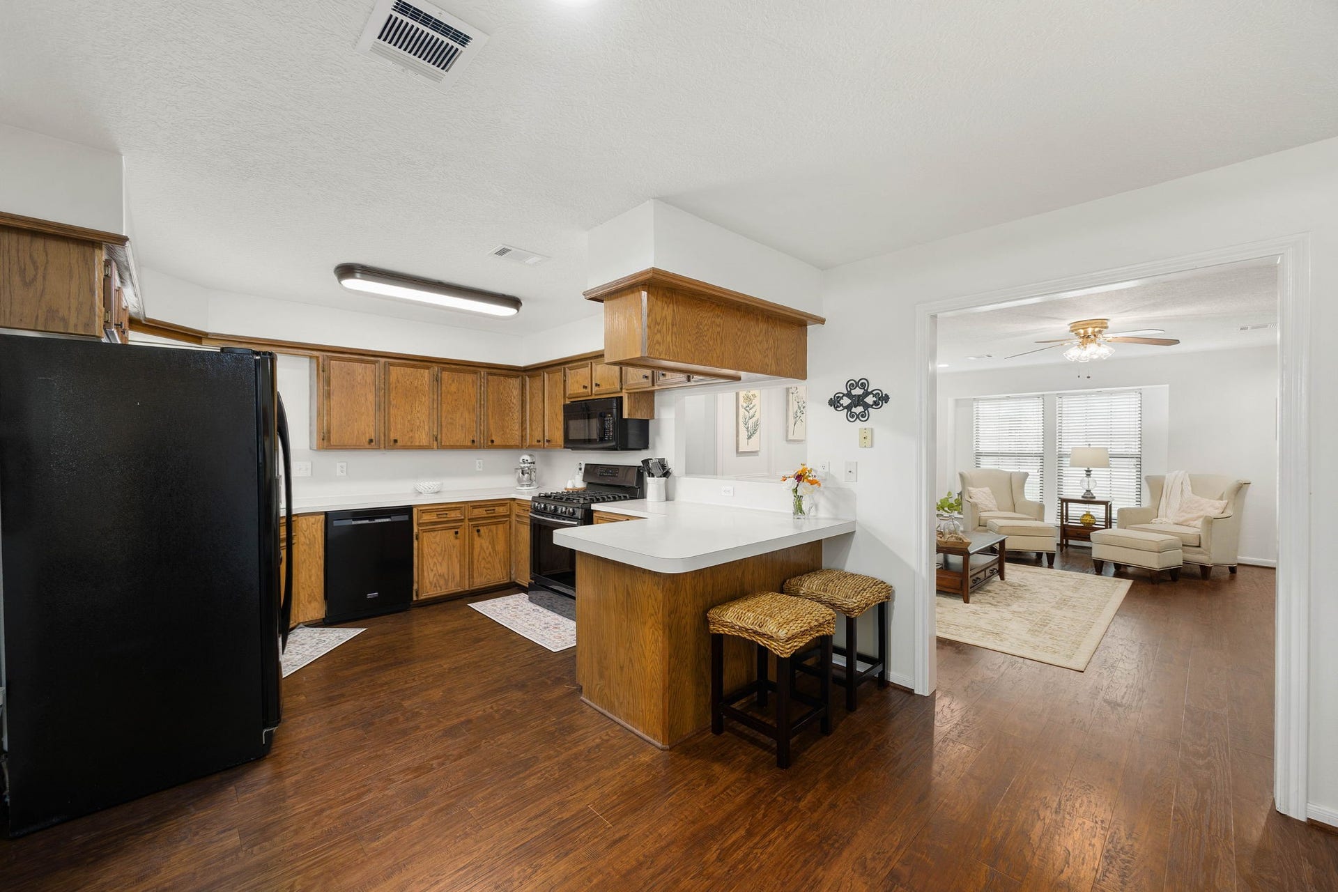 Functional kitchen features ample cabinetry, generous prep space, and a breakfast bar.