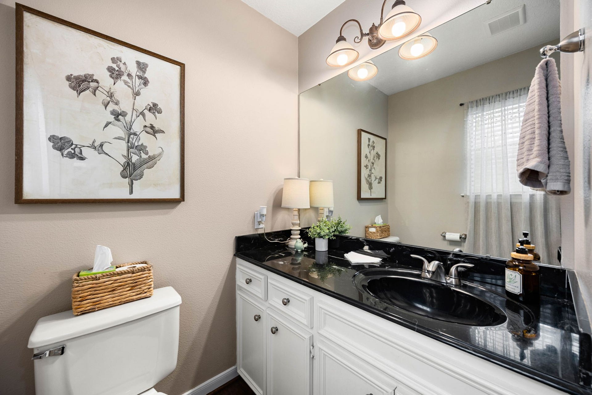 Convenient half bath serves the main living areas and guests.