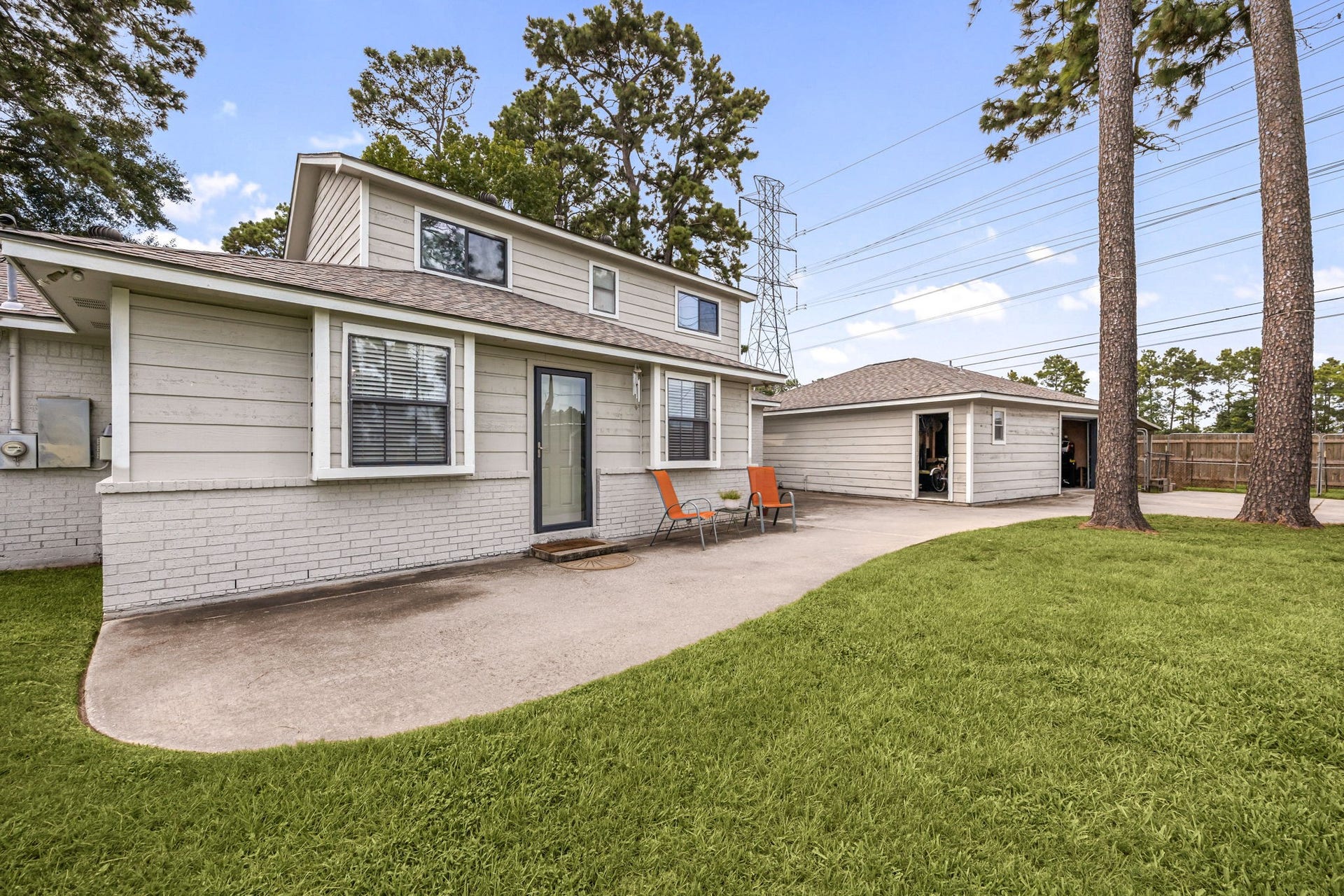 The back patio overlooks the expansive backyard and provides a space for outdoor relaxation.