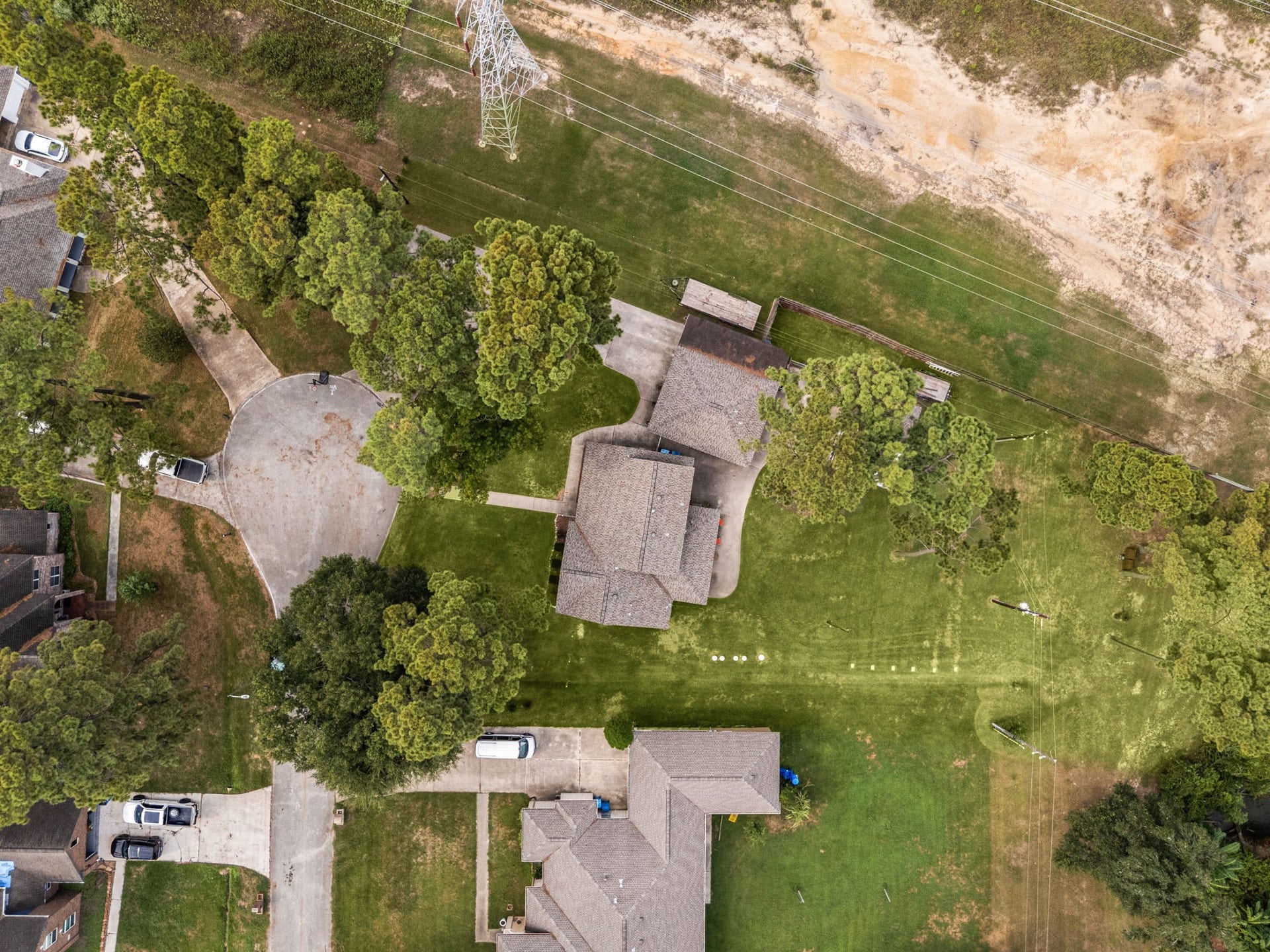 Overhead view offering a look at the home, surrounding grounds, and neighboring landscape.