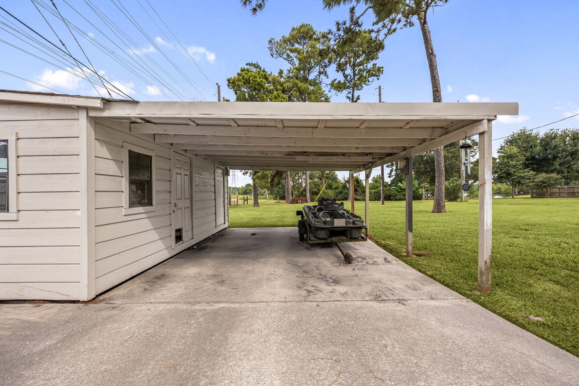 Additional covered parking adds convenience and versatility to the property.
