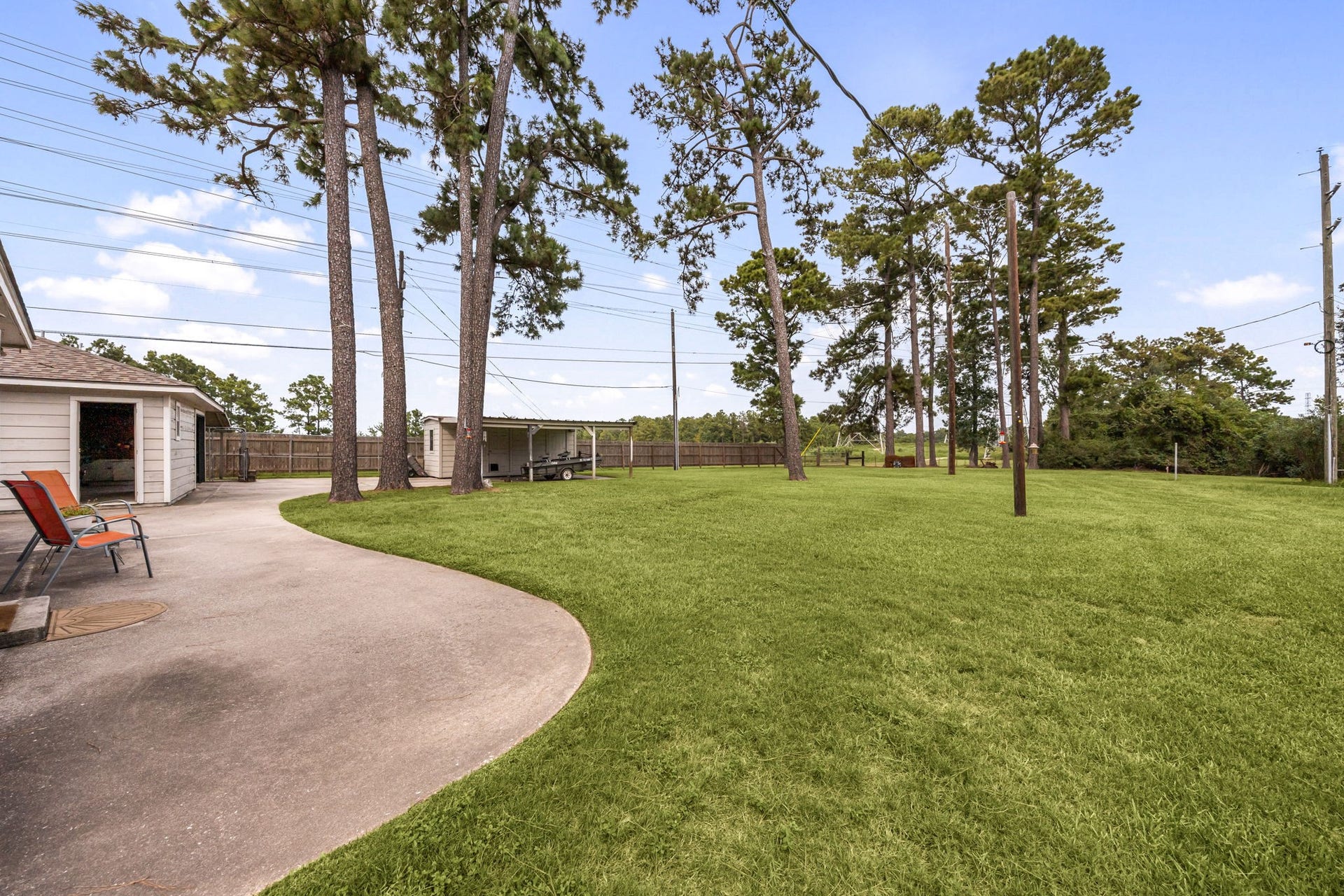 Another view of the expansive backyard and mature tree-lined setting.
