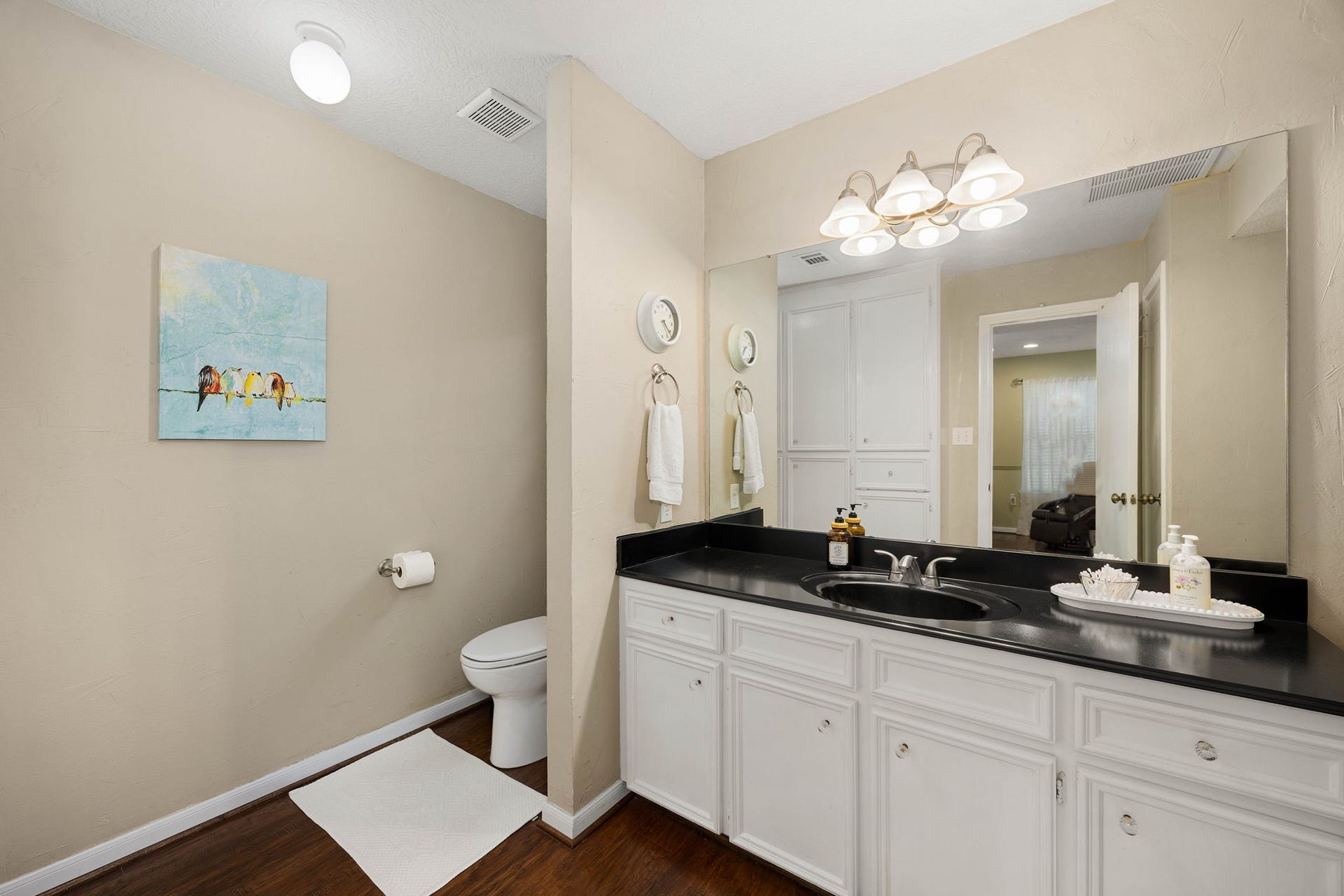 Primary bath features a spacious vanity and convenient storage.