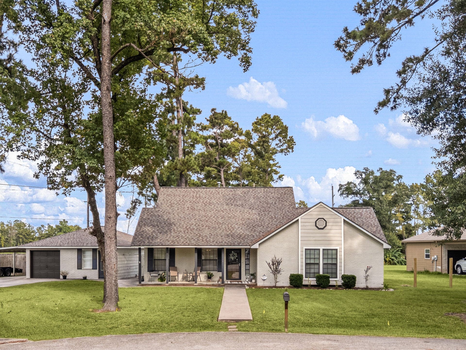 This home is nestled among mature trees.