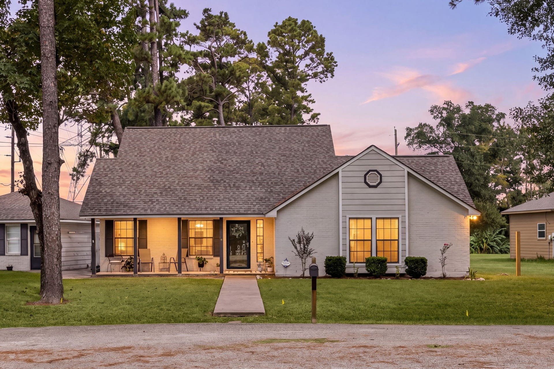Charming traditional home surrounded by mature trees on a spacious homesite.
