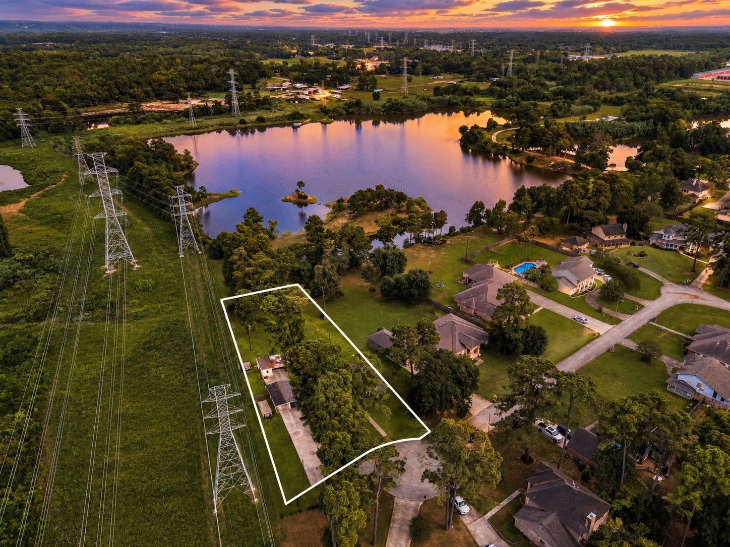 Outline of the lot showing the lake. Image sky and grass has been enhanced using AI.