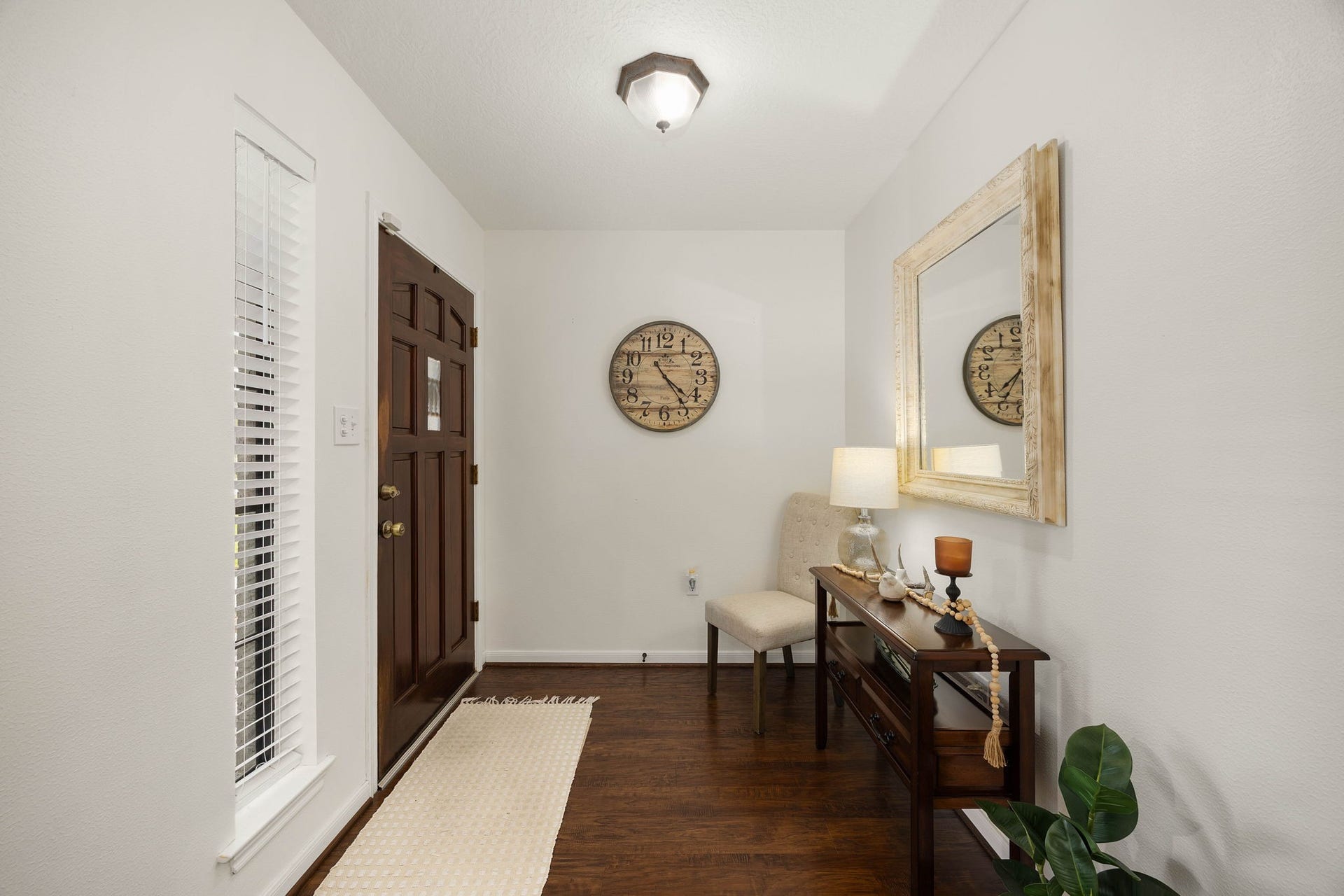 Bright entryway welcomes you inside with warm flooring and a comfortable flow into the home.