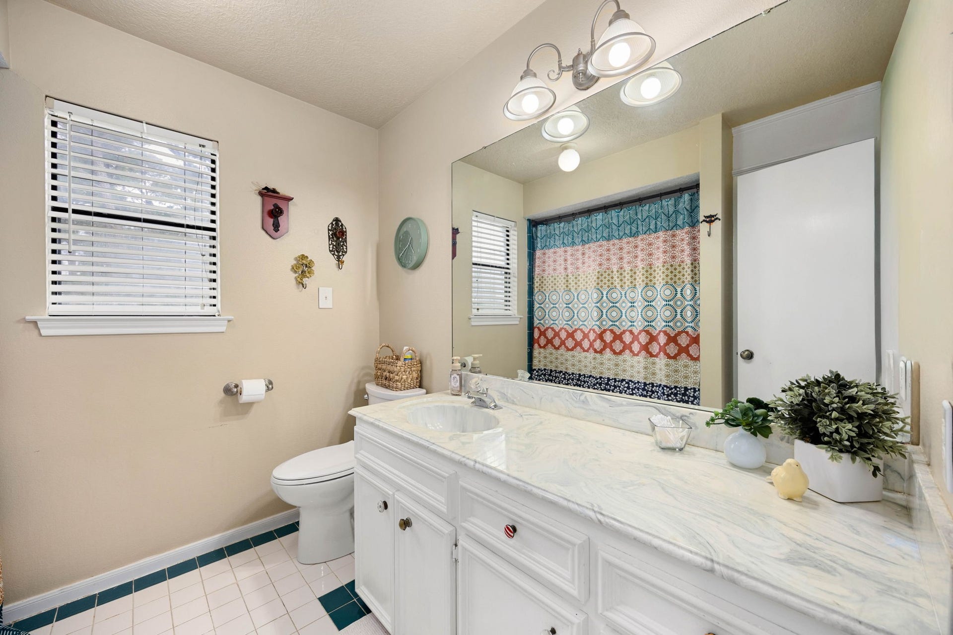 Secondary bath features a generous vanity and functional layout.