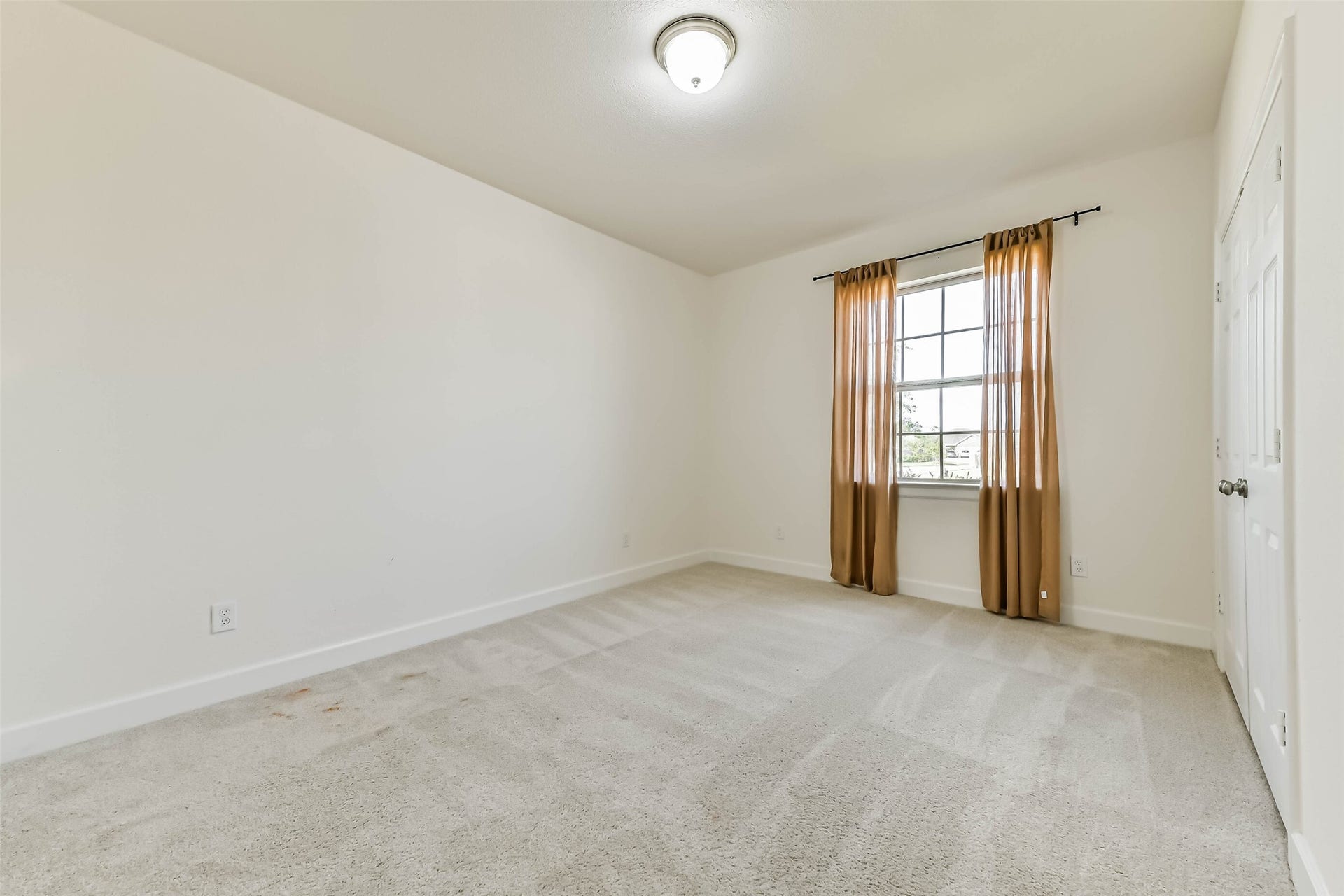 702 Campbell Drive, League City, TX 77573 Bright and inviting secondary bedroom #4 featuring a cozy bed, stylish decor, and a large window with warm curtains that allow natural light to fill the space.