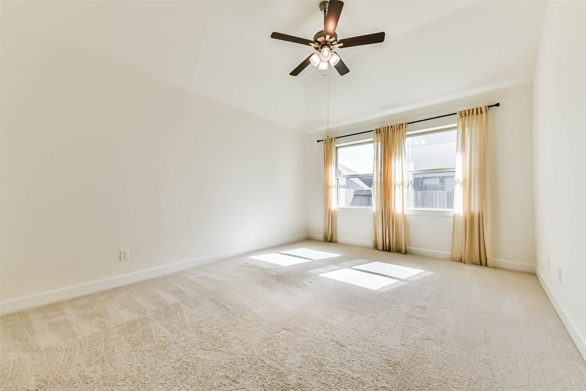 702 Campbell Drive, League City, TX 77573 Spacious and inviting Primary bedroom with abundant natural light, featuring a cozy bed, elegant dresser, and plush carpeting for ultimate comfort.
