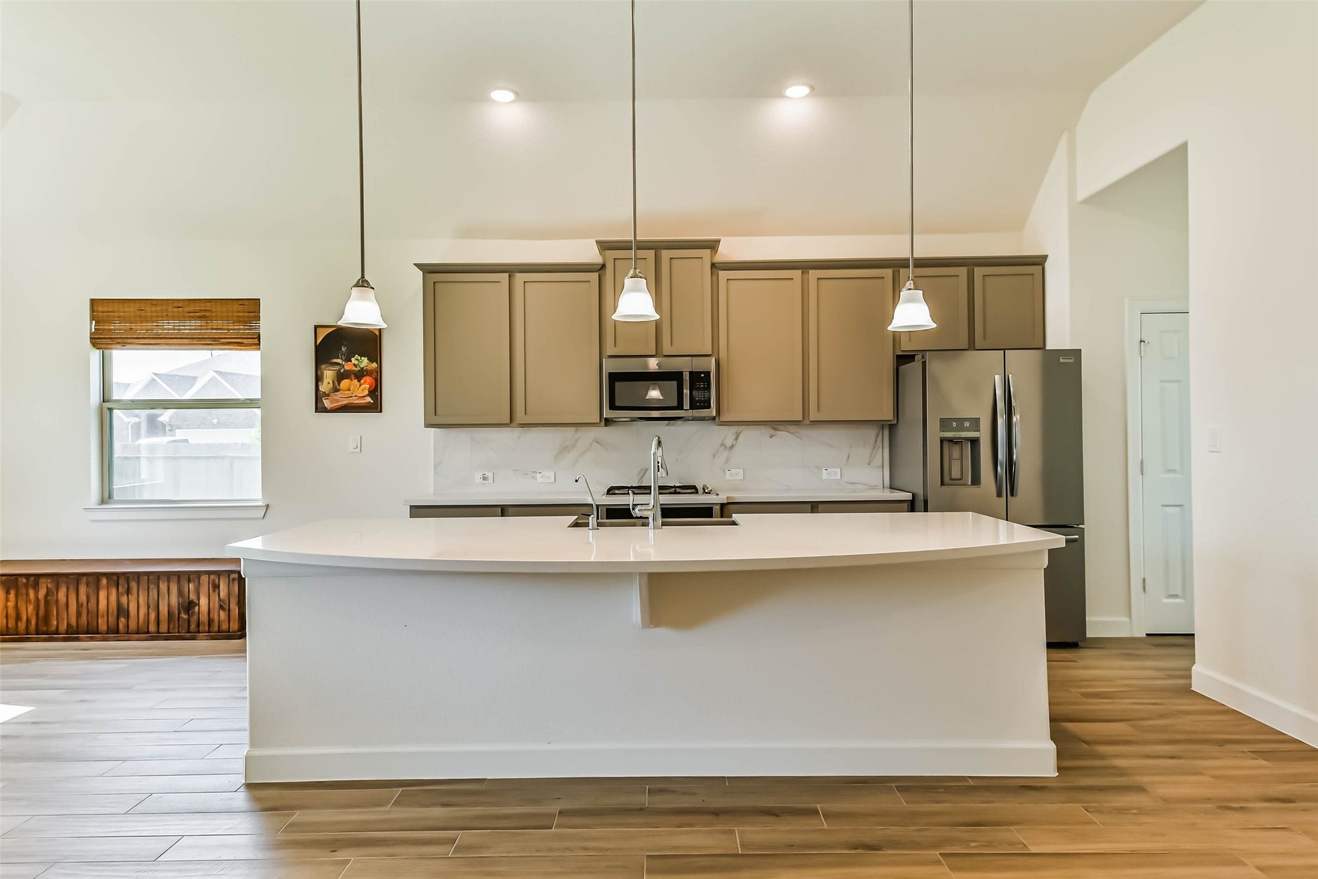 702 Campbell Drive, League City, TX 77573 Modern kitchen with sleek cabinetry, stainless steel appliances, and a spacious island with pendant lighting, perfect for entertaining.