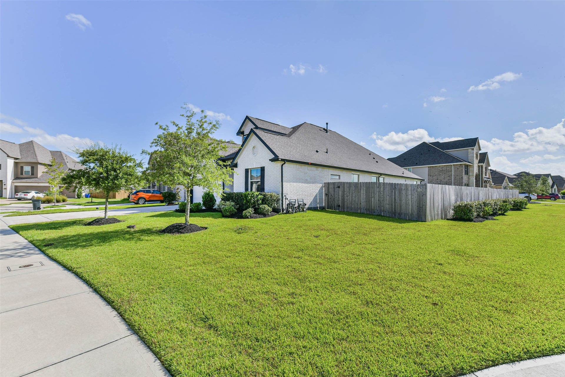 702 Campbell Drive, League City, TX 77573 Charming modern home on a spacious corner lot, featuring a well-maintained lawn and a cozy fenced backyard in a peaceful neighborhood.