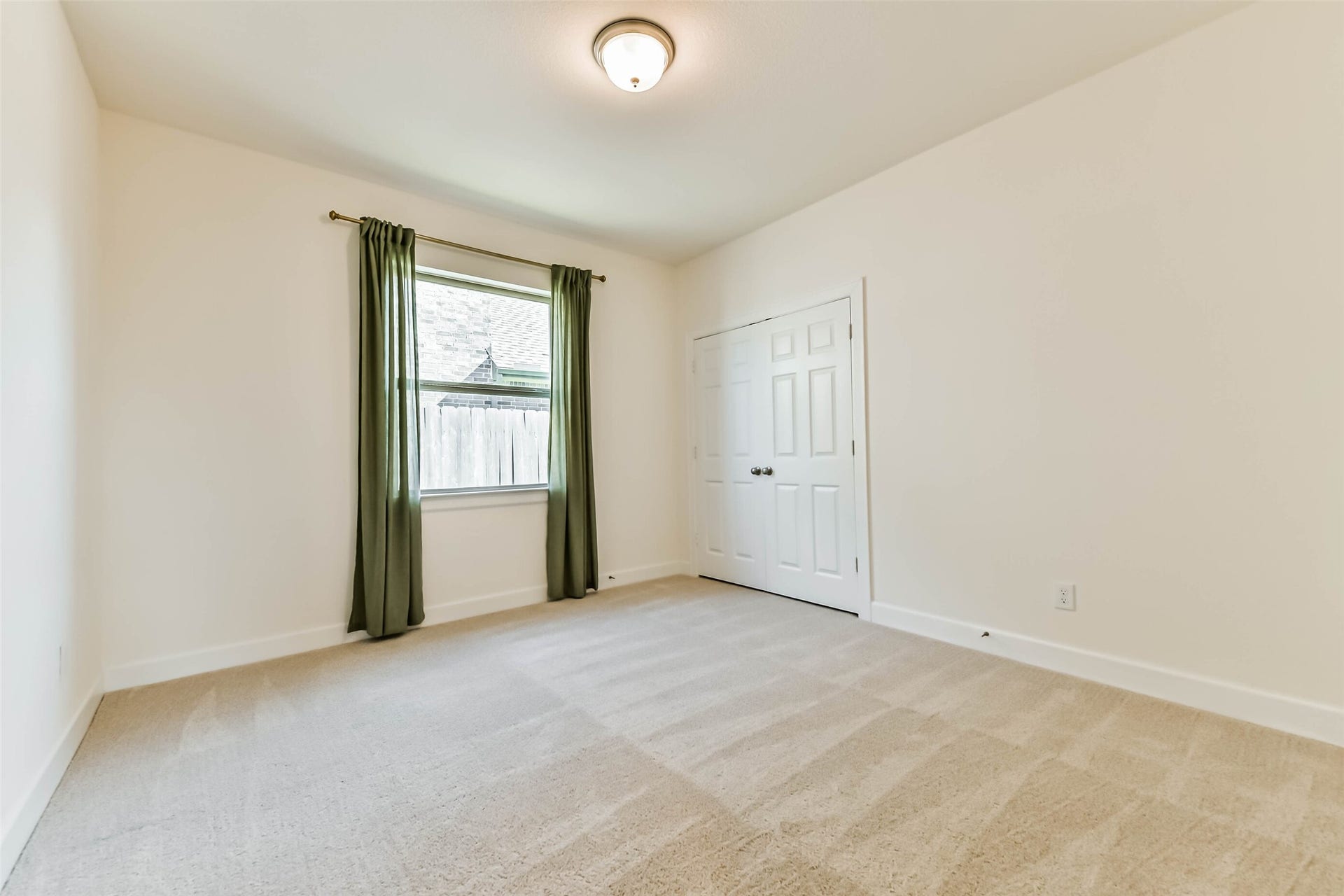 702 Campbell Drive, League City, TX 77573 Charming and cozy bedroom #3 featuring soft pastel decor, a canopy bed, and ample natural light from a large window, perfect for a child's retreat.