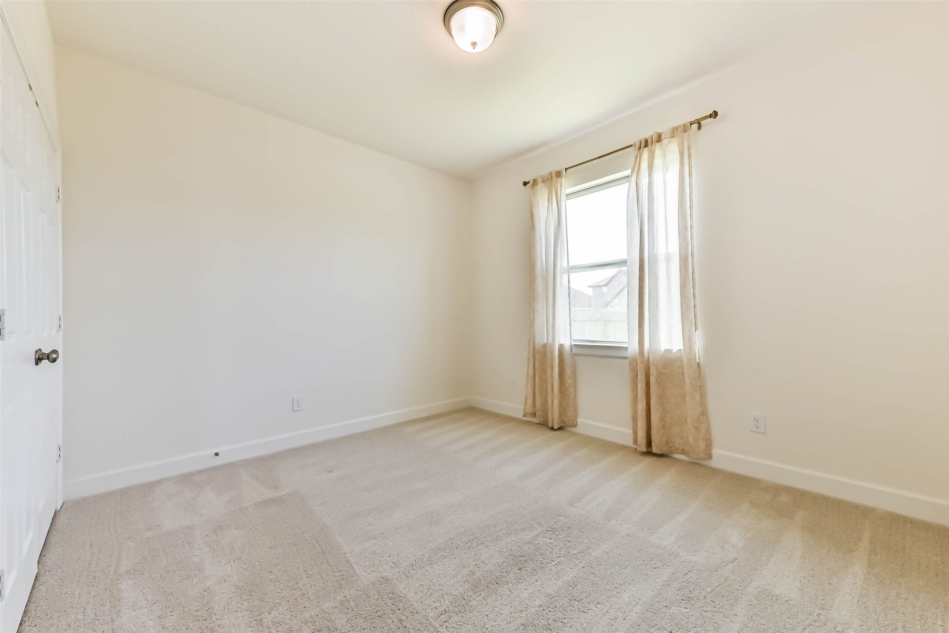 702 Campbell Drive, League City, TX 77573 Spacious bedroom #2 with serene neutral finishes, generous layout, and abundant natural light
