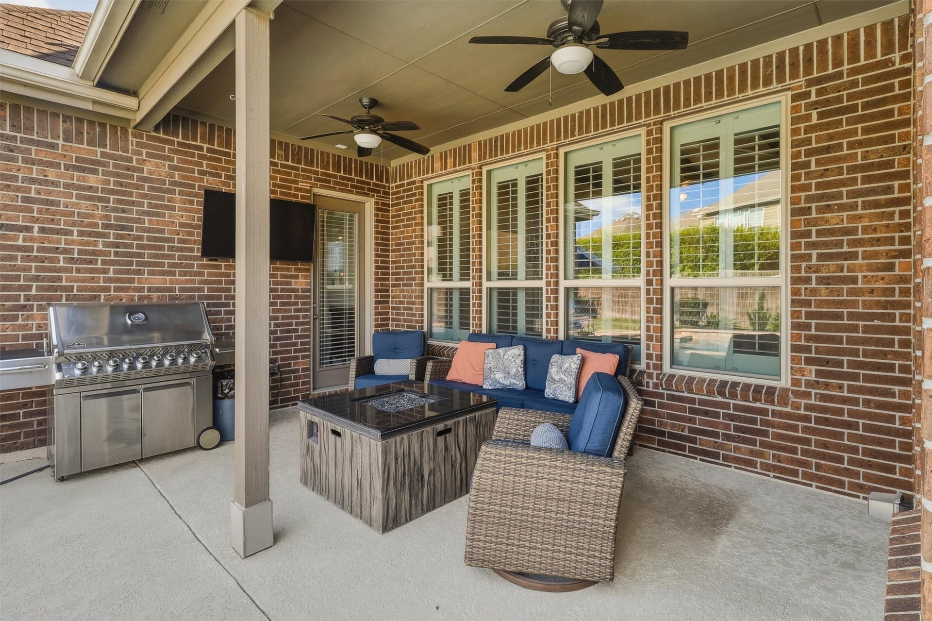 1407 Trails Of Katy Lane, Katy, TX 77494 Imagine the appetizers out and your favorite playlist on. The covered patio accommodates a relaxed seating arrangement beside the pool area, creating a comfortable home base for outdoor entertaining. The pictured gas grill is excluded from the sale.