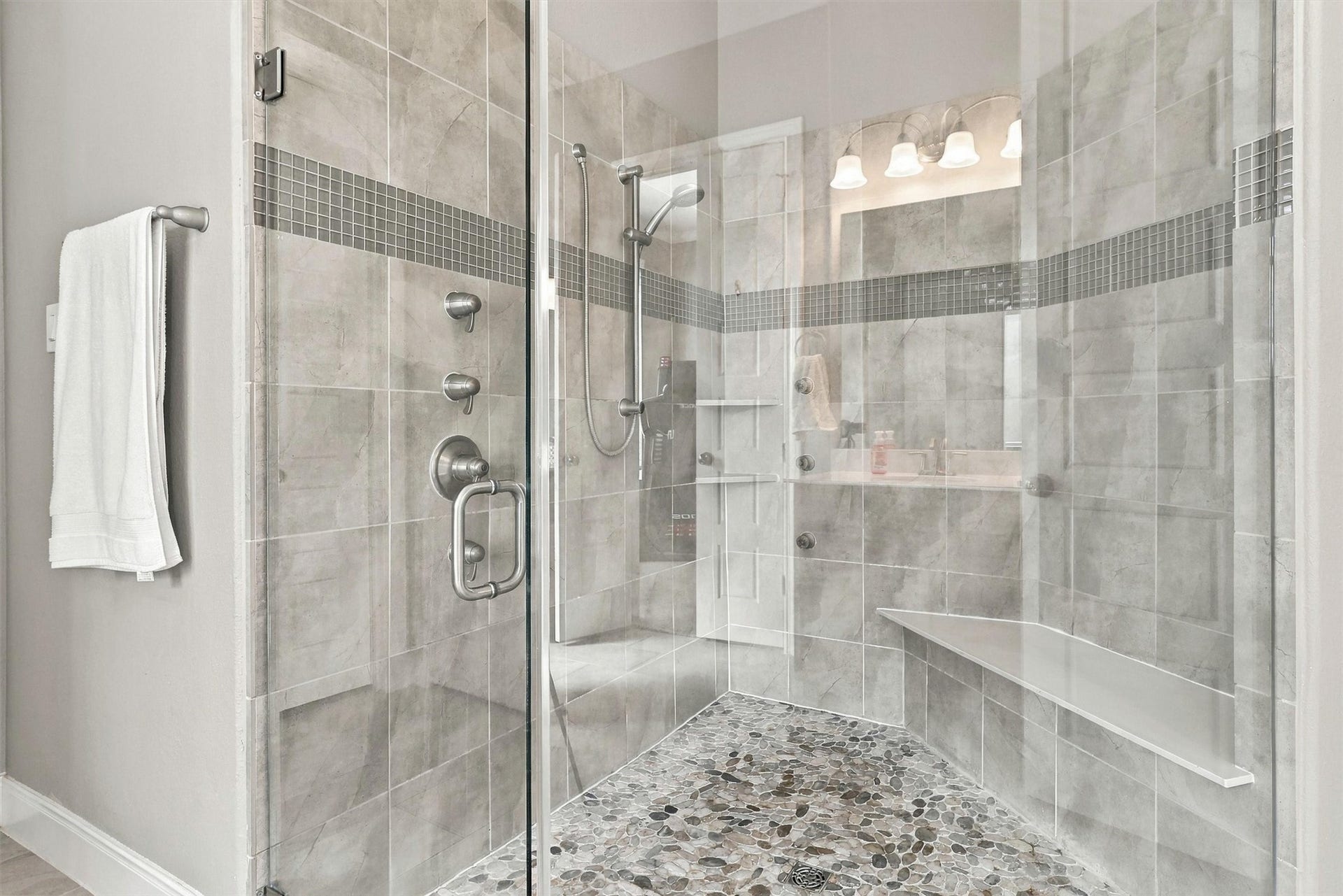 1407 Trails Of Katy Lane, Katy, TX 77494 The details turn this shower into a retreat. The builders selected spa-shower package includes a rainfall showerhead, three body sprays and a handheld showerhead, complemented by a tiled seat and decorative tilework.