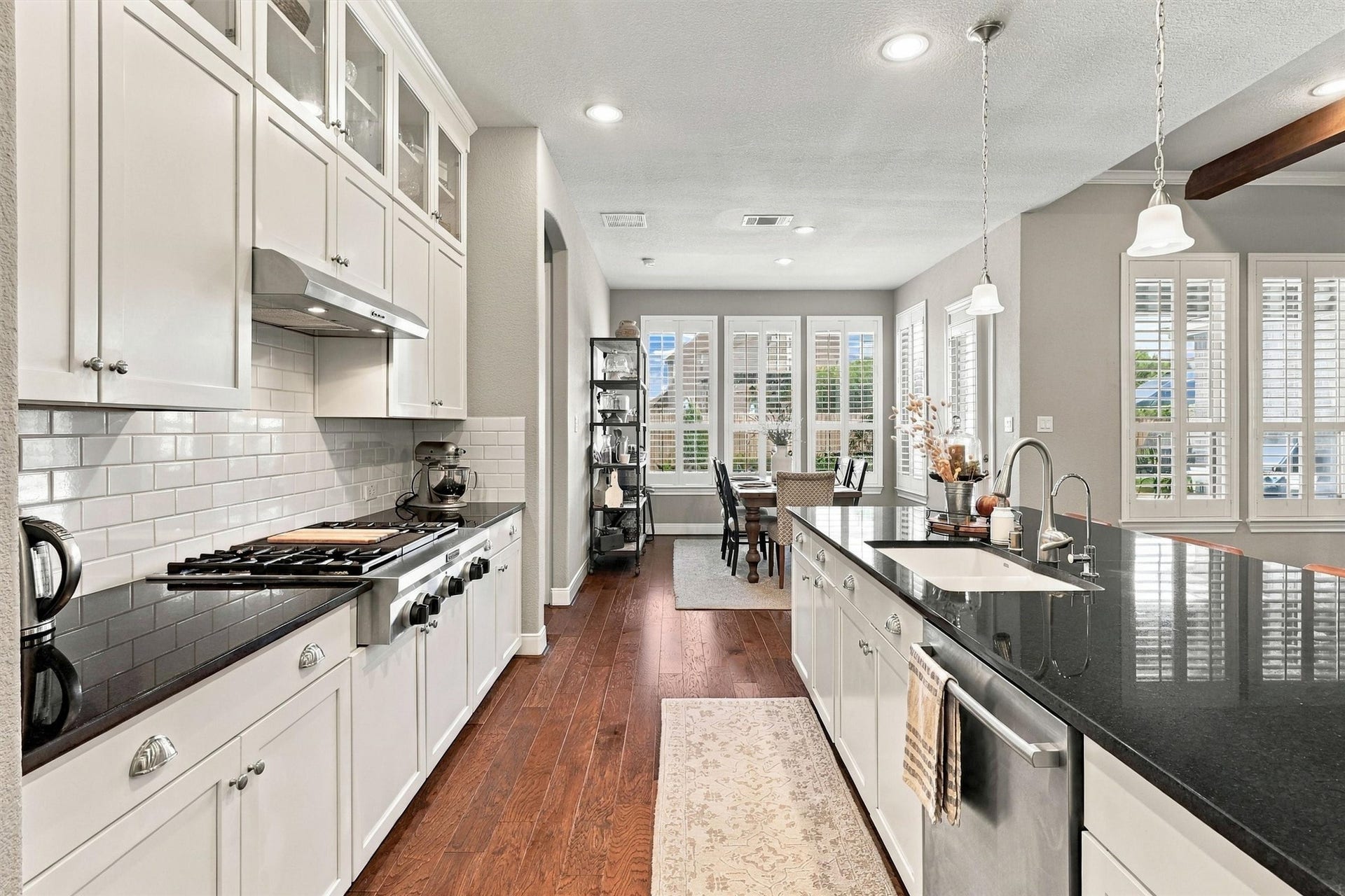1407 Trails Of Katy Lane, Katy, TX 77494 Look beyond the beautiful cabinetry to the details that make cooking more enjoyable. Generous counters, a decorative backsplash and under-cabinet lighting create useful workspace, with the island close by for plating, serving and casual conversation.