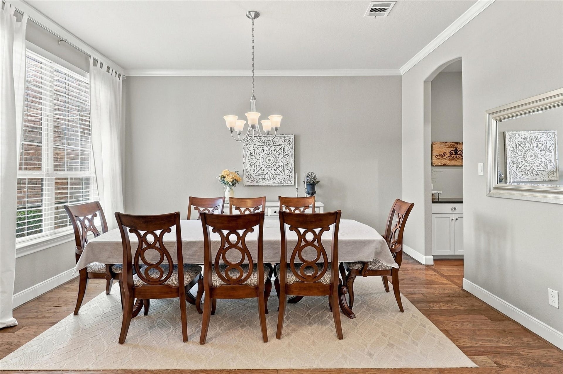 1407 Trails Of Katy Lane, Katy, TX 77494 Picture the table set, candles glowing and your favorite people gathering for dinner. Crown molding, plantation shutters and a statement chandelier give the formal dining room an elegant backdrop for holiday meals and evenings worth lingering over.