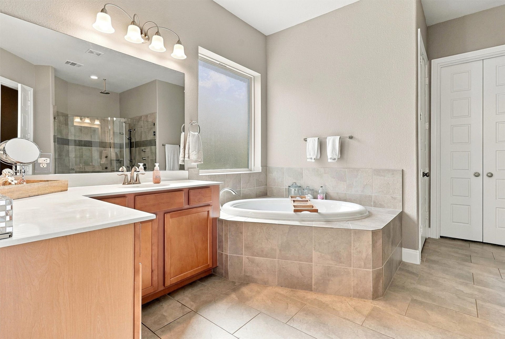 1407 Trails Of Katy Lane, Katy, TX 77494 Give your morning routine a little more room. The primary bathroom features a soaking tub, separate vanities and a generous tiled floor area, with the upgraded shower nearby for whichever way you prefer to unwind.