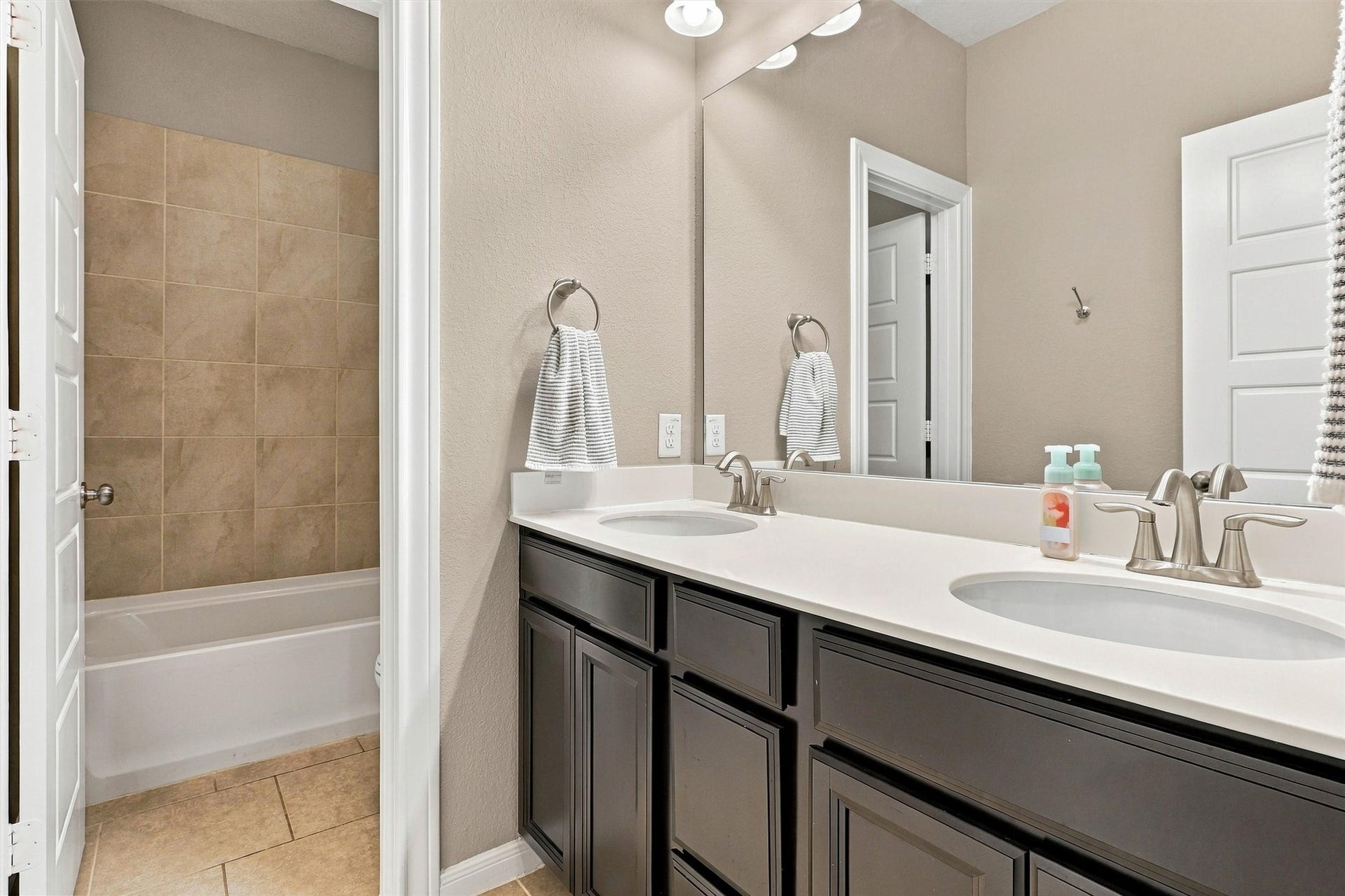 1407 Trails Of Katy Lane, Katy, TX 77494 Generous counter space and cabinetry make this upstairs vanity area useful for busy mornings. Keep toiletries tucked away and daily essentials within reach, with the adjacent bathing area adding convenience to the layout.