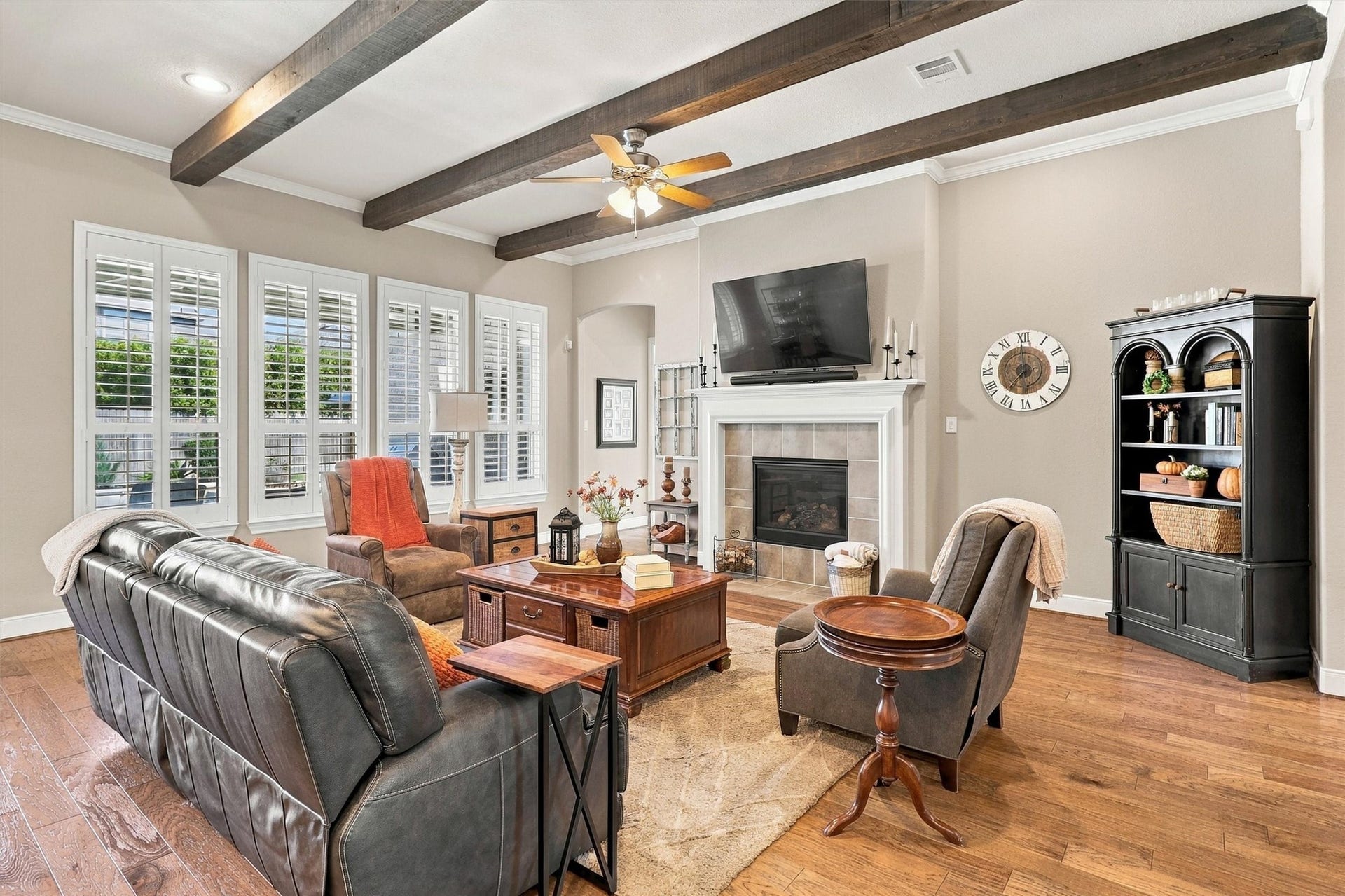 1407 Trails Of Katy Lane, Katy, TX 77494 This is where the conversation keeps going. Cedar-wrapped ceiling beams, a gas-log fireplace and warm wood flooring give the expansive living room character, while its connection to the kitchen lets the host stay part of the gathering.
