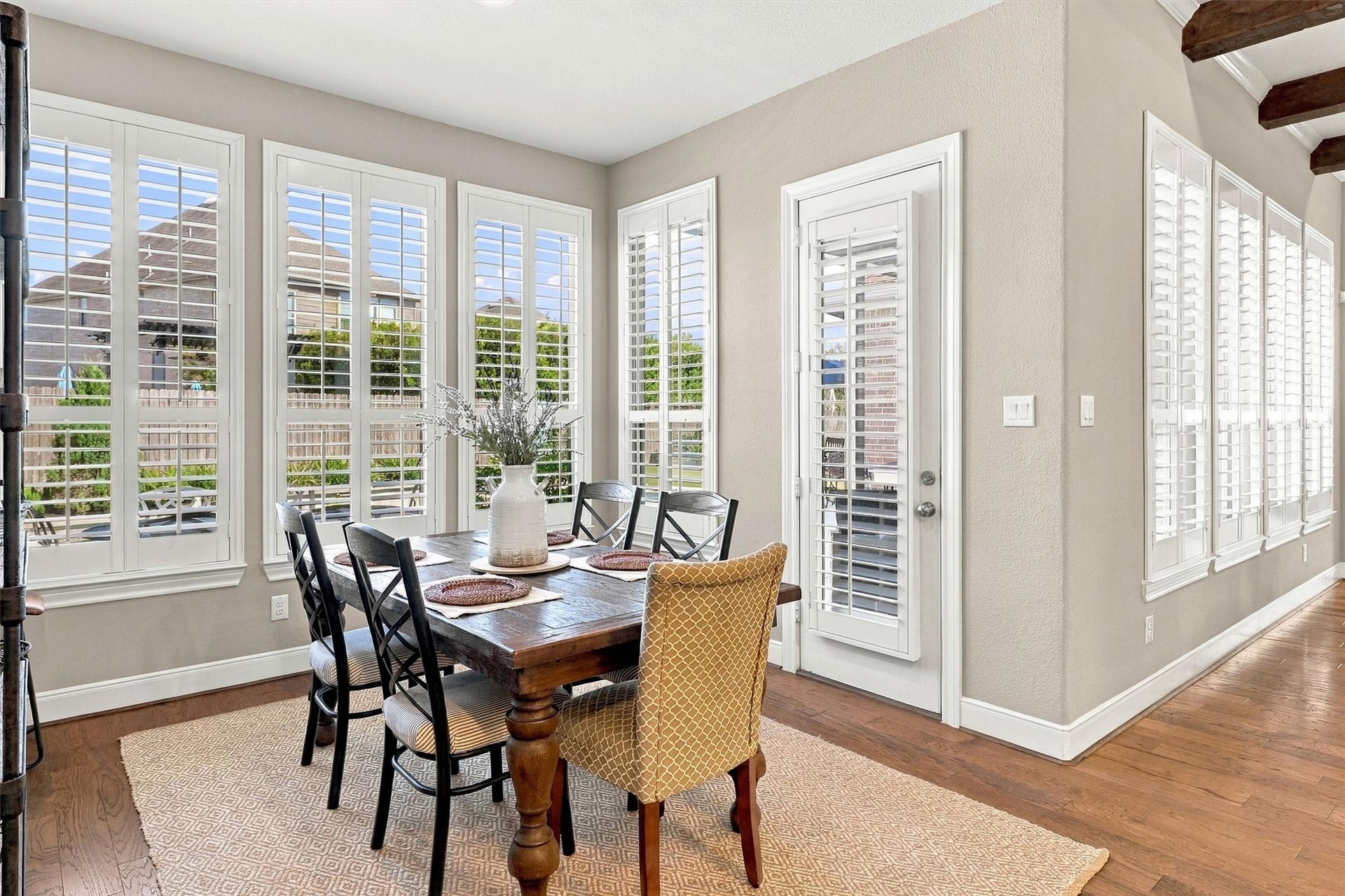 1407 Trails Of Katy Lane, Katy, TX 77494 Start the day with coffee and a backyard view. The window-lined breakfast area sits beside the kitchen and patio access, offering a cheerful spot for everyday meals before the evenings entertaining begins.
