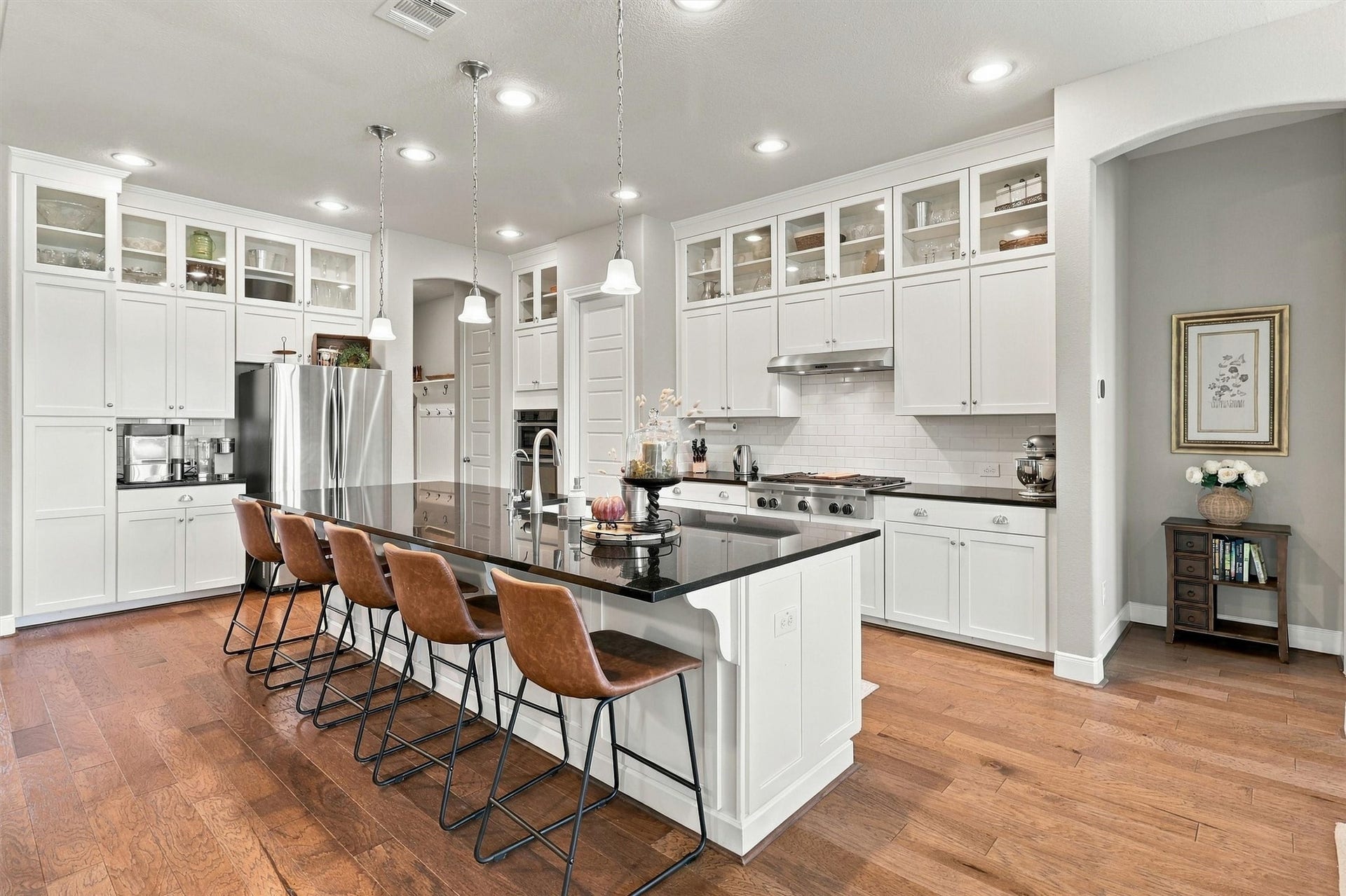 1407 Trails Of Katy Lane, Katy, TX 77494 A kitchen designed to be part of the party. The open layout connects island seating with the living room and breakfast area, giving guests places to gather without separating the host from the conversation.