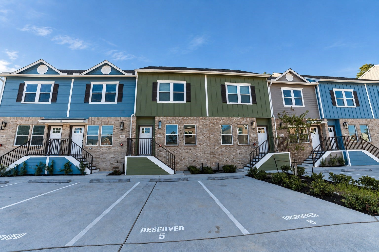 3248 Creekmont Drive, Houston, TX 77091 Charming modern townhouses with vibrant facades, offering reserved parking and welcoming front entrances.