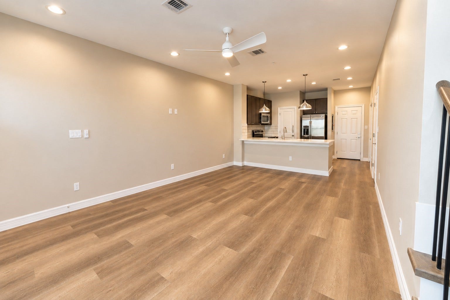 3248 Creekmont Drive, Houston, TX 77091 Spacious open-concept living area with sleek vinyl floors, recessed lighting, and a modern kitchen featuring stainless steel appliances and stylish pendant lights.