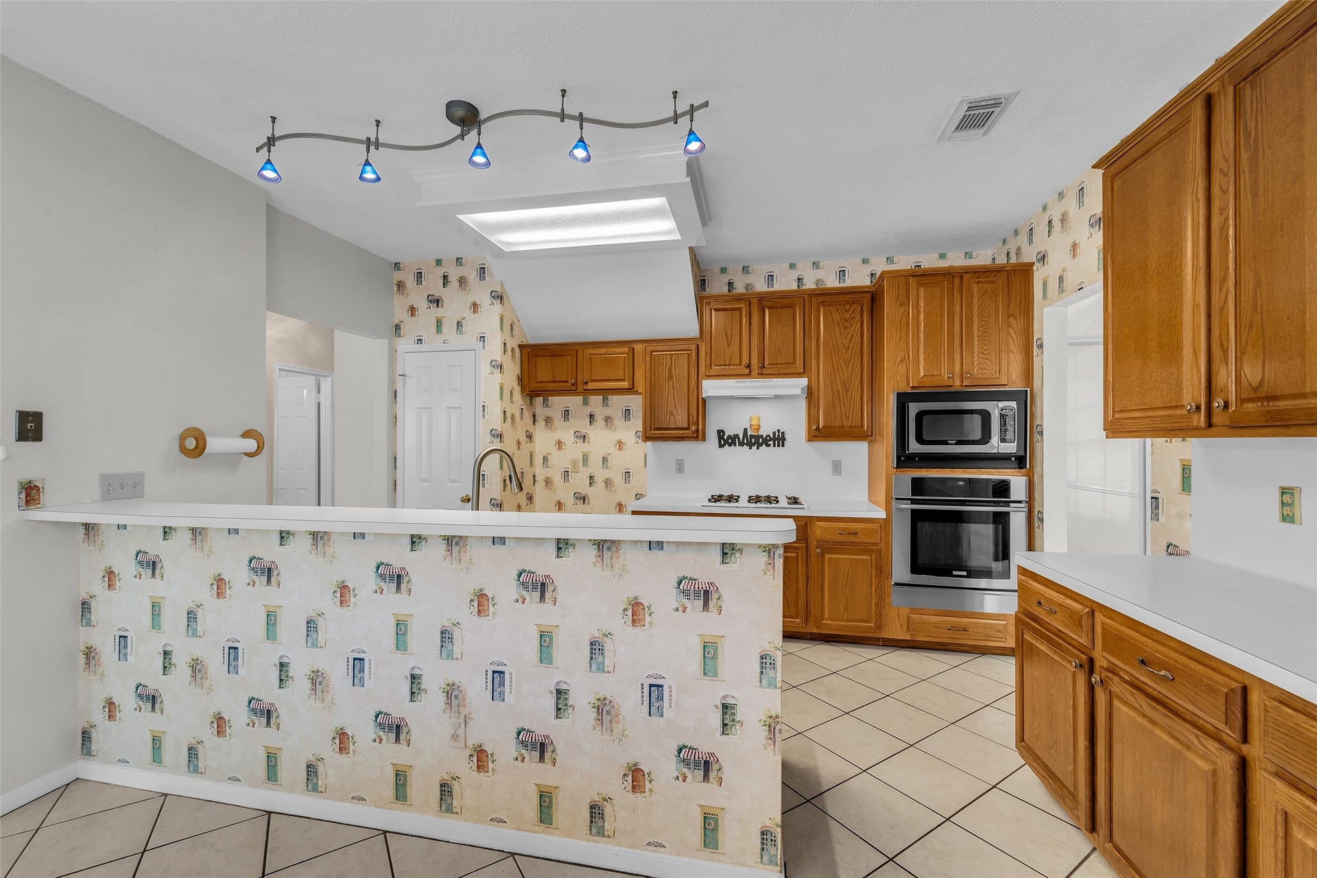 1344 Coleman Boylan Drive, League City, TX 77573 Charming kitchen with classic wooden cabinetry with a cozy breakfast bar.