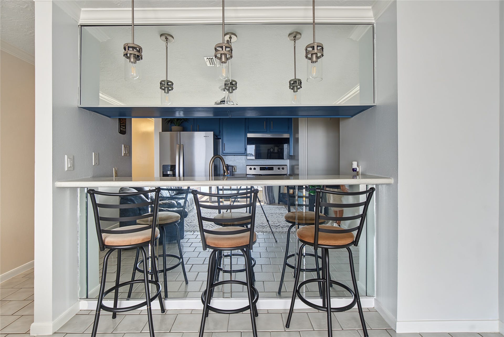 Breakfast bar with seating for three creates an inviting space for casual dining and entertaining.